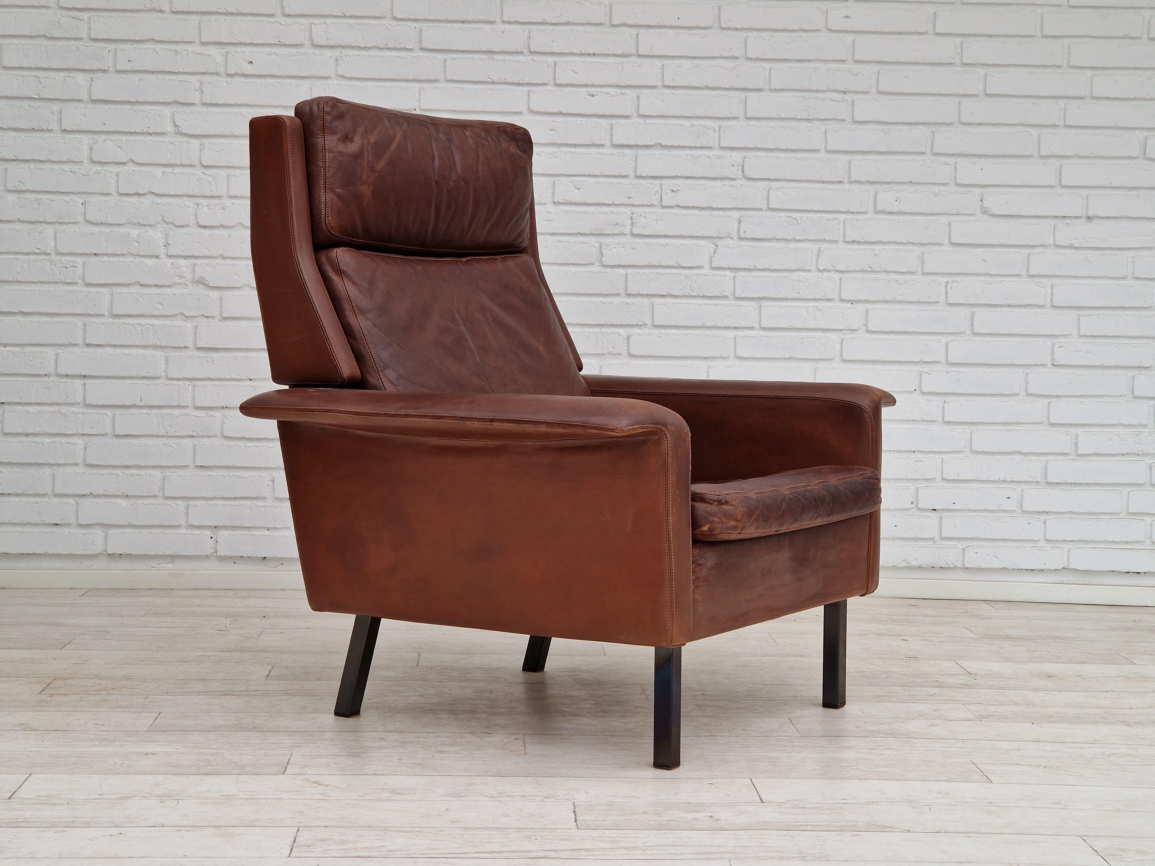 1970s, Danish design by Arne Vodder, model 7401. High back armchair in original dark camel-brun leather with a nice patina. Original very good condition: no smells and no stains. Legs of steel and lose cushions. Made by Danish furniture manufacturer