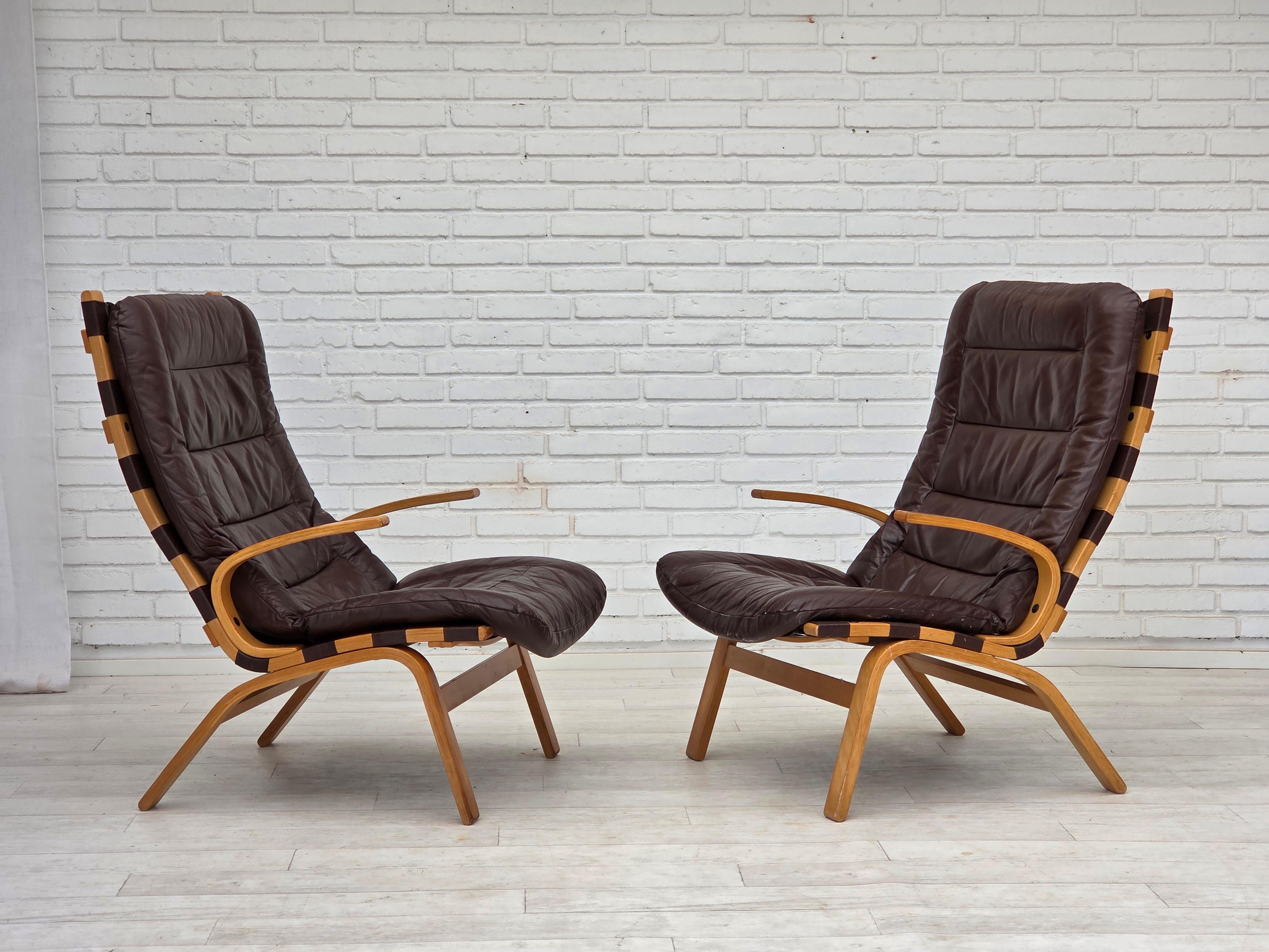 1970s, Danish design by Farstrup. Set of 2 armchairs. Original brown furniture leather, bent wood, canvas. Original good condition: no smells, no stains and stable construction. Manufactured by Danish furniture maker Farstrup Møbler in about