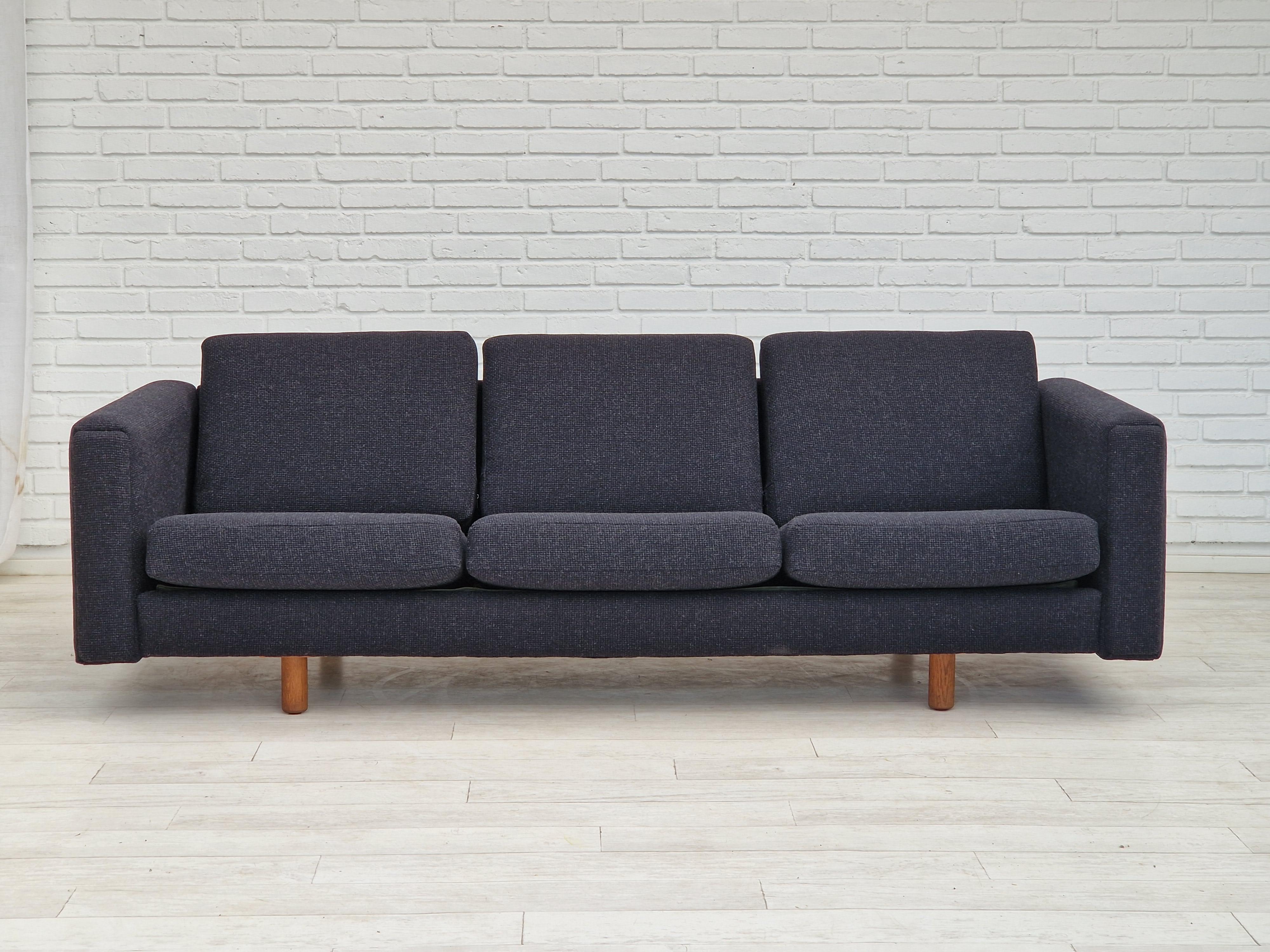 1960s-70s, Danish design by H.J. Wegner. Completely renovated-reupholstered 3 seater sofa model GE300. Quality furniture wool fabric Glasgow in charcoal grey. Brand new upholstery and cushions. Oak legs. Manufactured by Danish furniture manufacturer