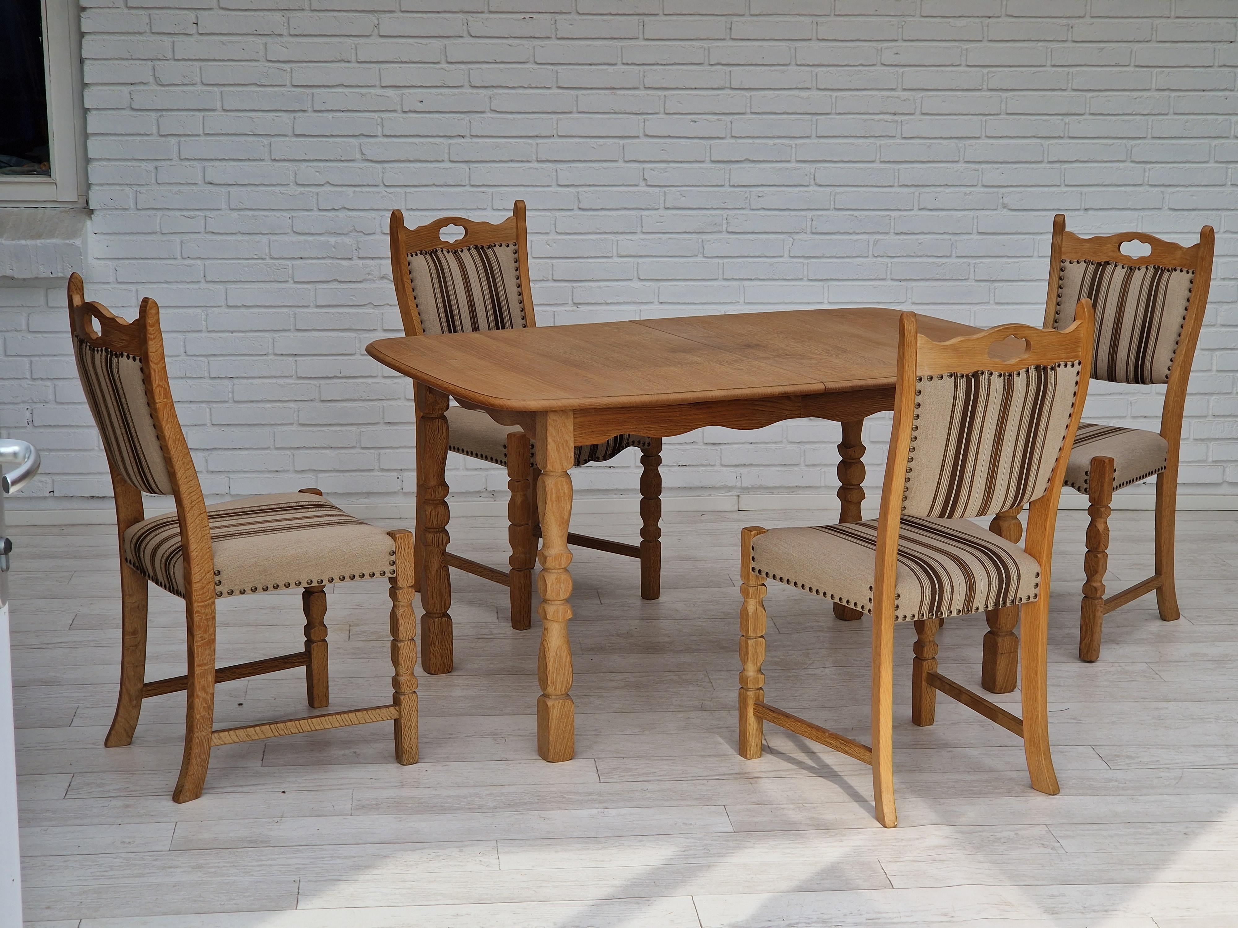 1970s, Danish design. Dinning set of unfolded table and four chairs. Oak wood, chair seats reupholstered in furniture wool. Solid oak wood original in very good condition. Folding table (with 3 additional plates - 50cm each ). Removable legs. Made