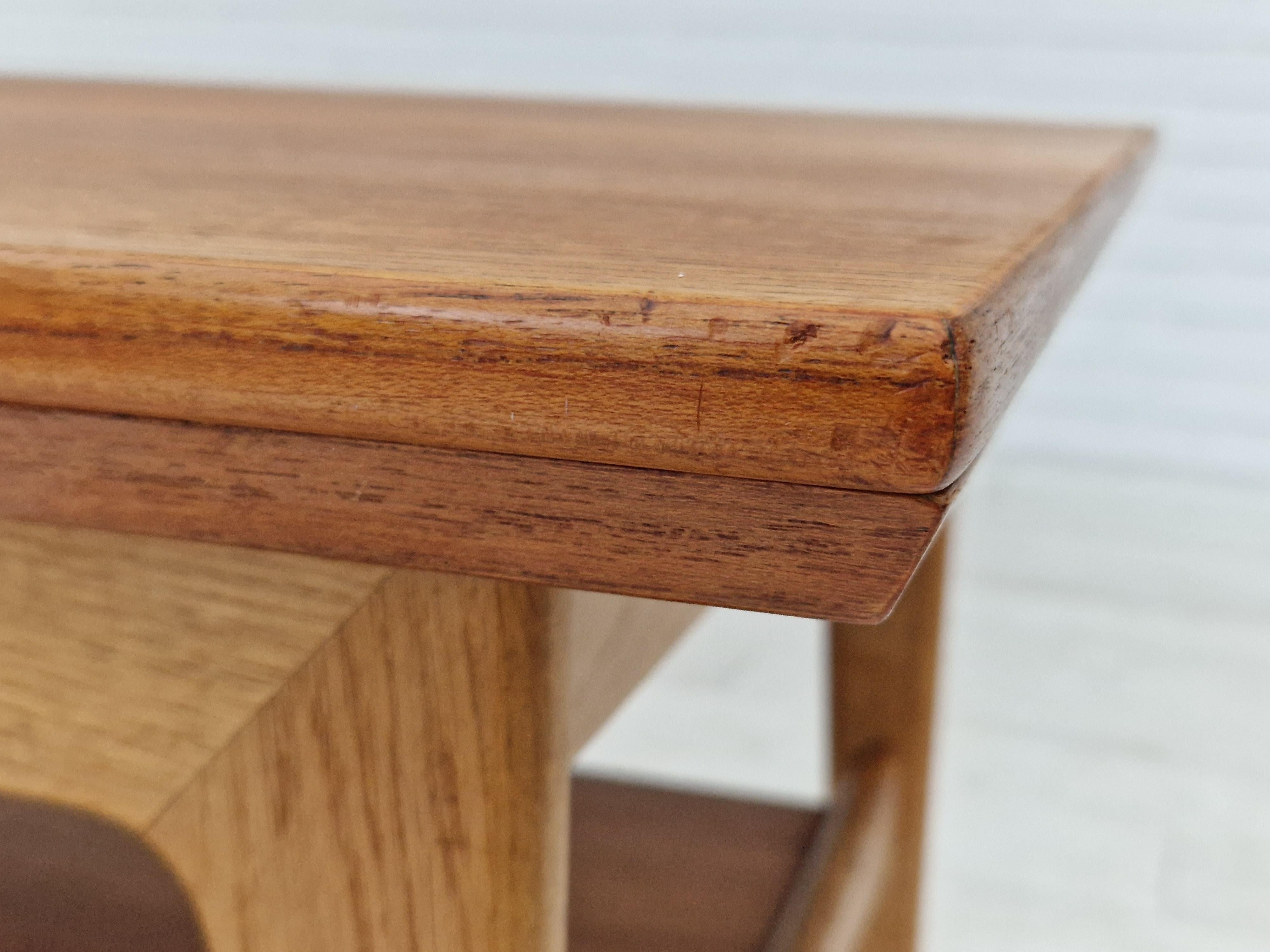 1970s, Danish design. Folding sofa table. Teak wood and oak wood. Tables top of teak wood, legs of oak wood. Shelf of teak wood. Original very good condition: no smells and no stains.