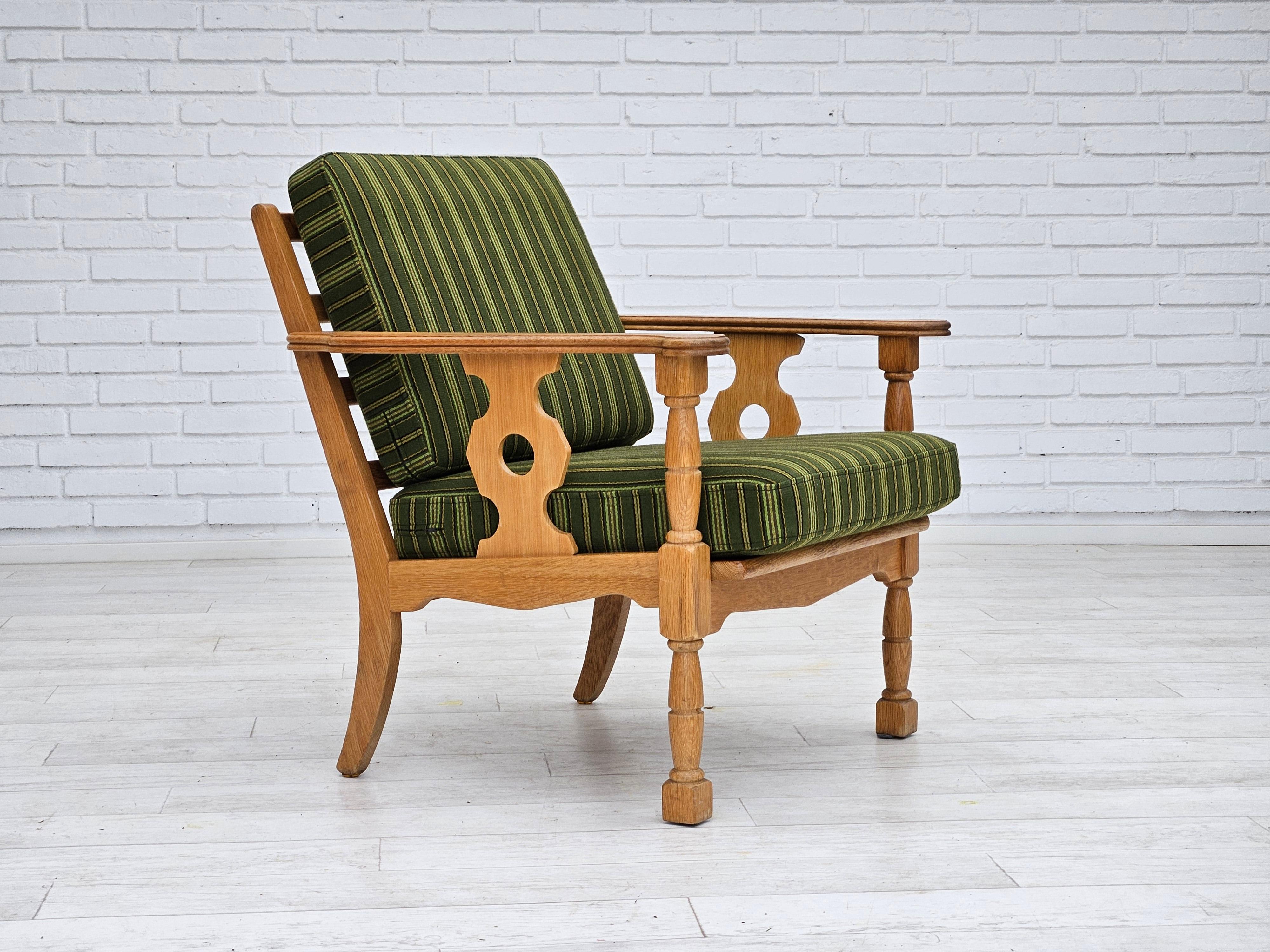 1970s, Danish armchair in original very good condition: no smells and no stains. Green furniture wool fabric, oak wood. Springs in the seat and back cushions. Manufactured by Danish furniture manufacturer in about 1975s.