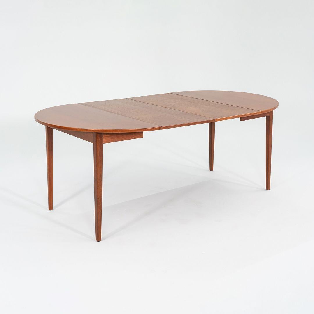This is a handsome Extension Dining Table dating to the 1970s, attributed to Ib Kofod Larsen of Denmark. The piece is crafted of solid and veneered teak and is accompanied by two removable leaves.
 
 When the leaves are removed, the table measures
