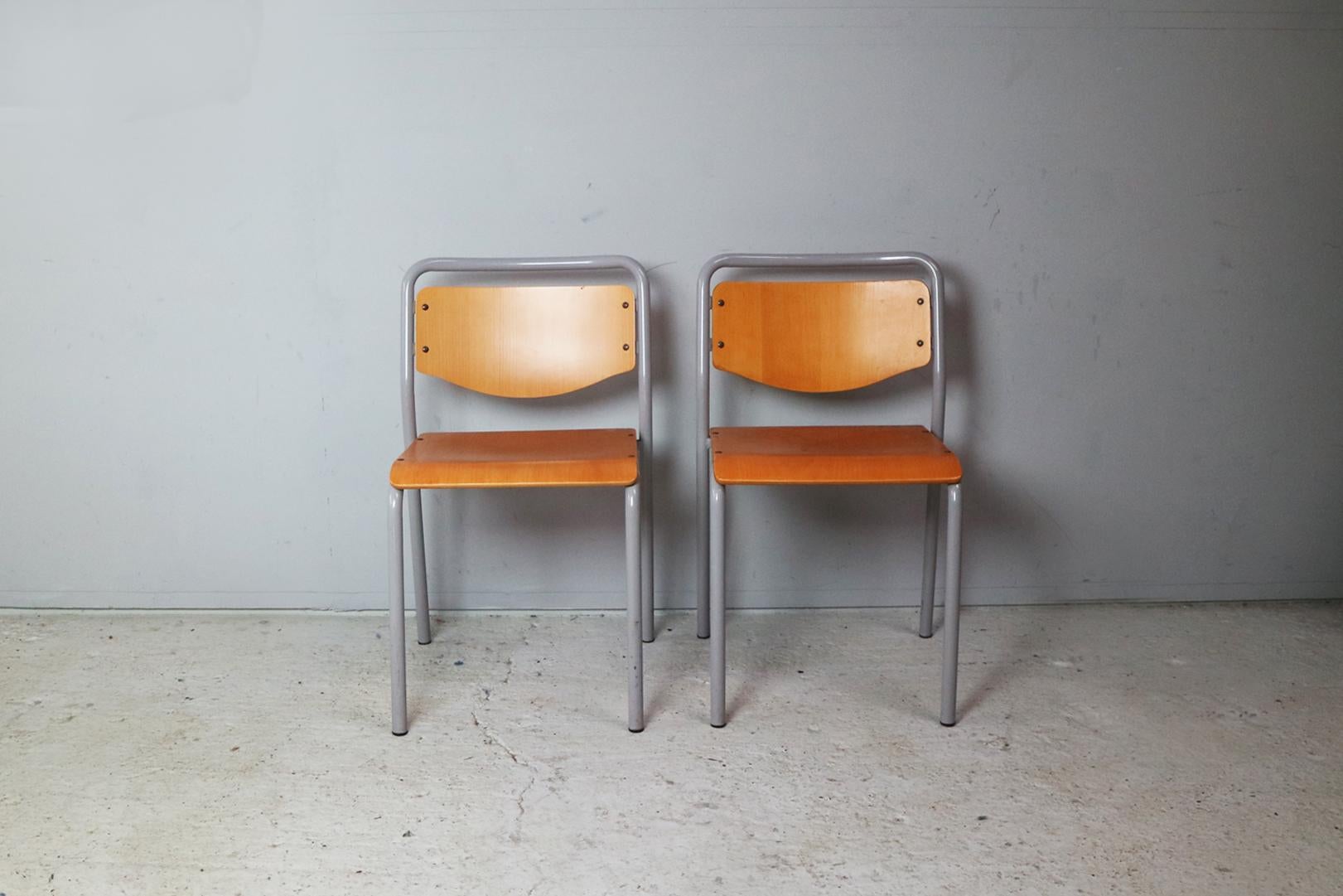 Great Scandinavian stacking functional / industrial style. Grey painted tubular metal frames with bent beech seat and back rest. Riveted detailing. The nice detail of an extending bar at the rear of the seat. Very sturdy and incredibly well
