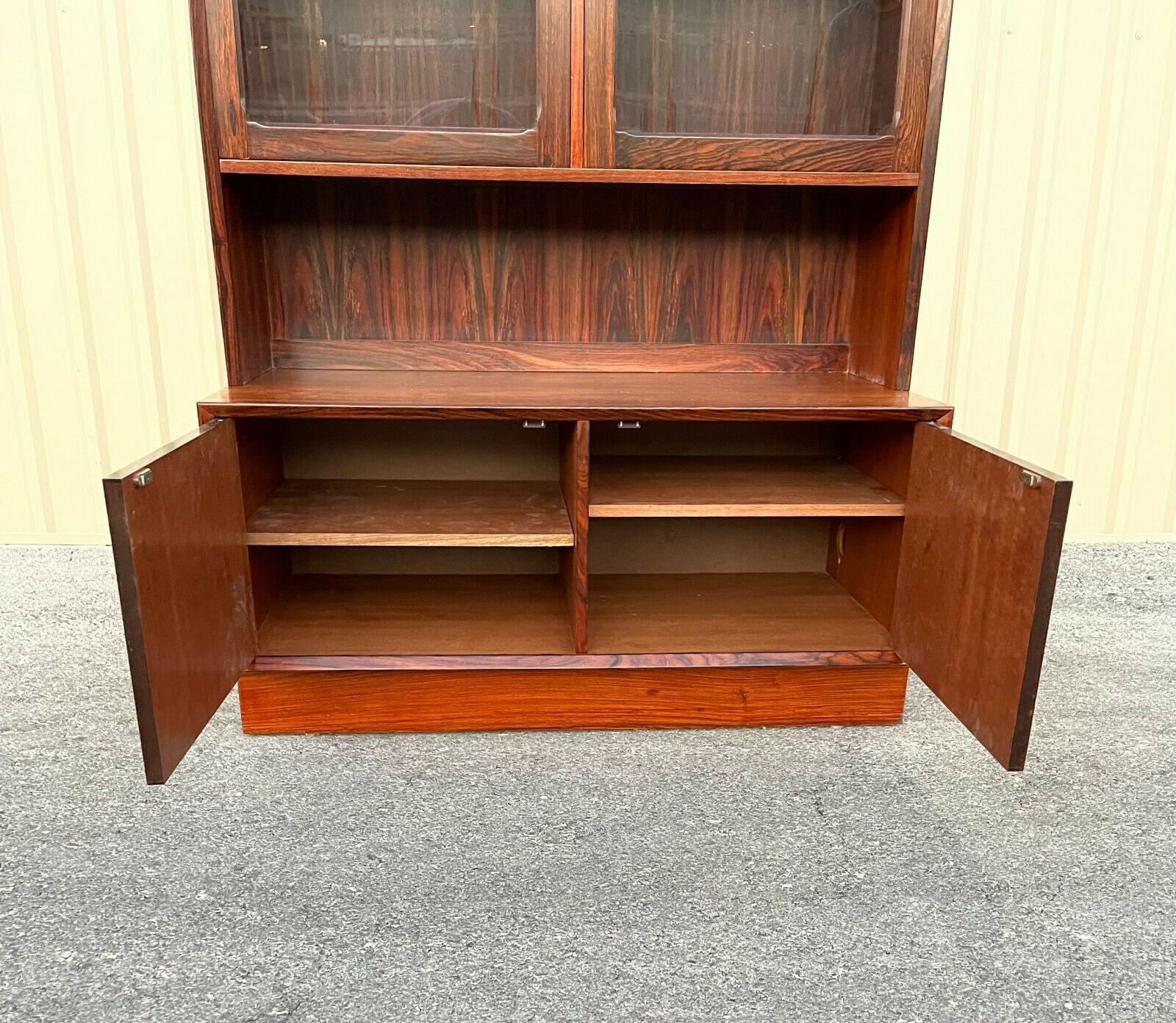 A Beautiful Danish modern rosewood display cabinet in 2 parts, designed by Erik Brouer for Brouer Møbelfabrik, Denmark, in the 1970s. It has very stunning wood grain and is refined in every detail. It is very beautifully made with 2 cabinet doors in