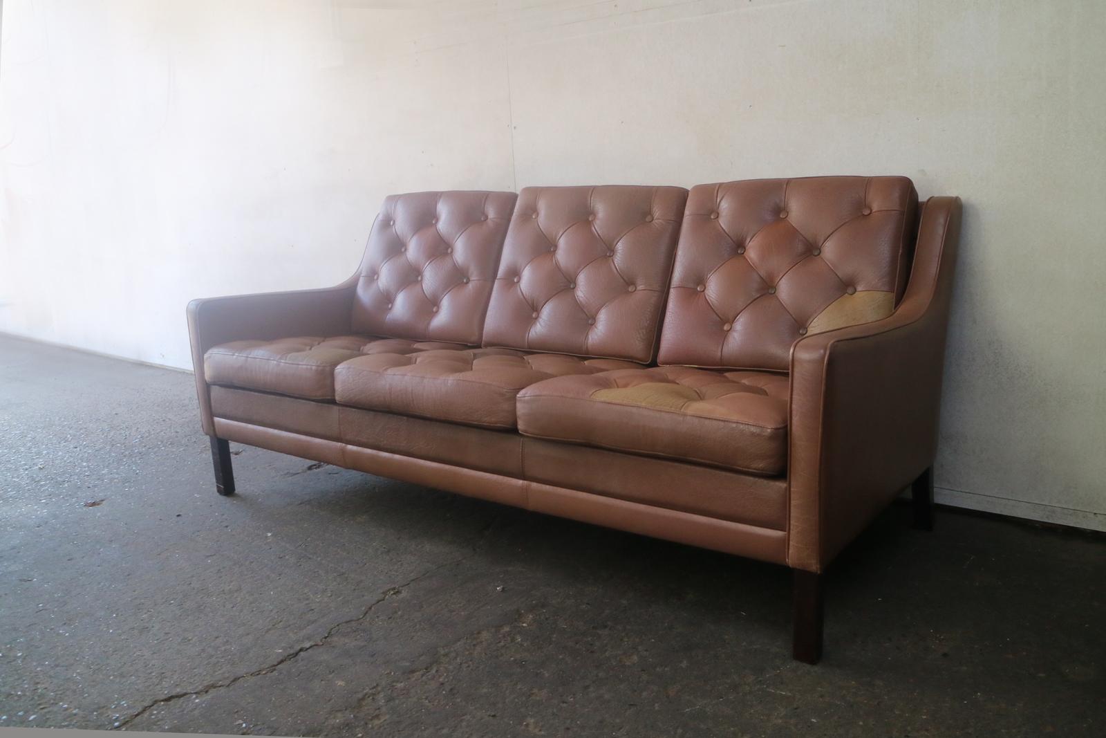 A handsome Danish sofa similar in style to the designs of Borge Mogensen. The diamond shaped sections are individual pieces of leather, with different colours appearing randomly throughout.

Country of origin: Denmark
Date of manufacture: