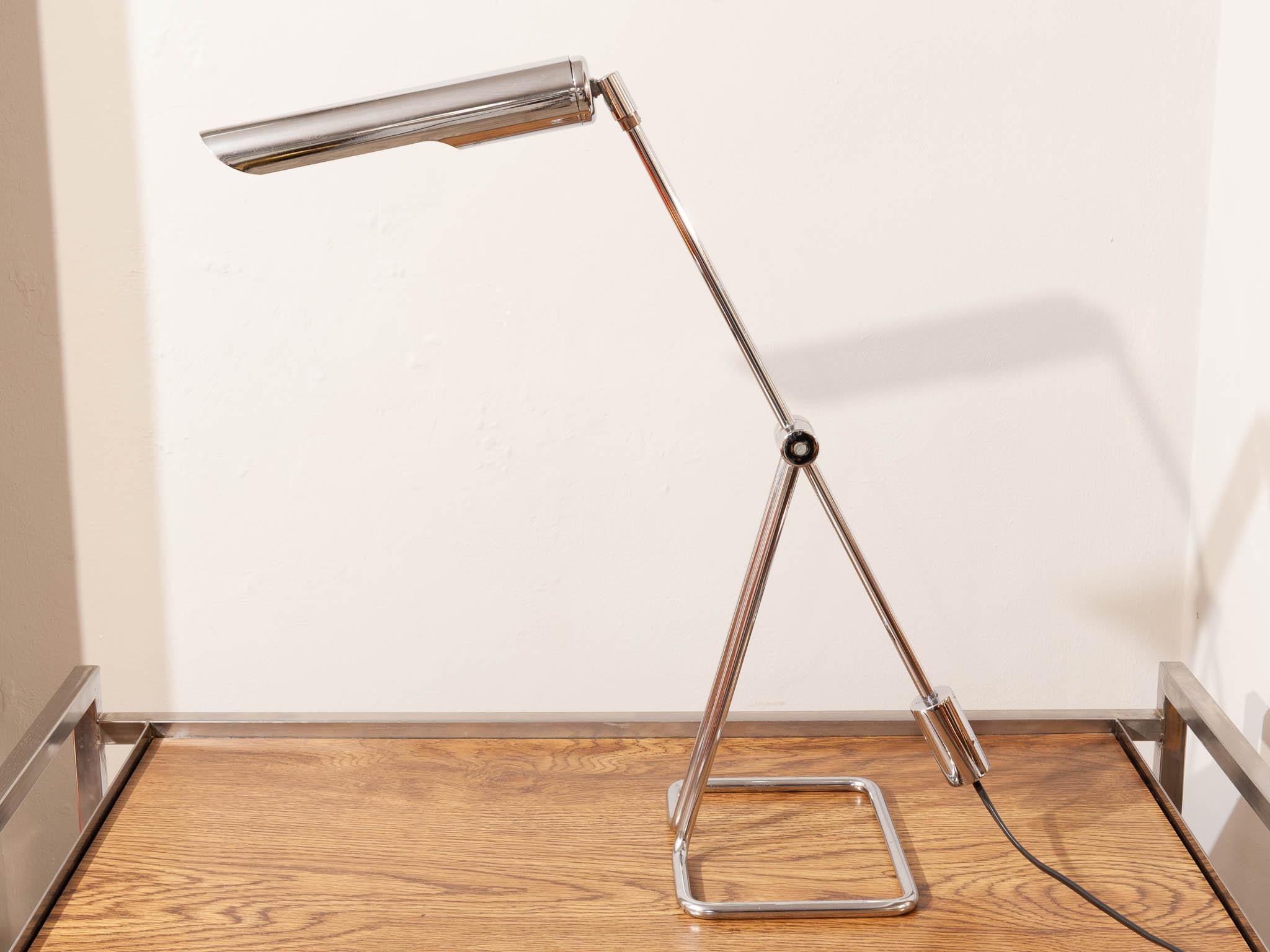 1970s Danish minimalist desk light designed by Abo Randers. As you can see from the images the lamp is adjustable in many different ways due to its simple but clever design. The light is chrome plated with a rectangular formed tubular base which