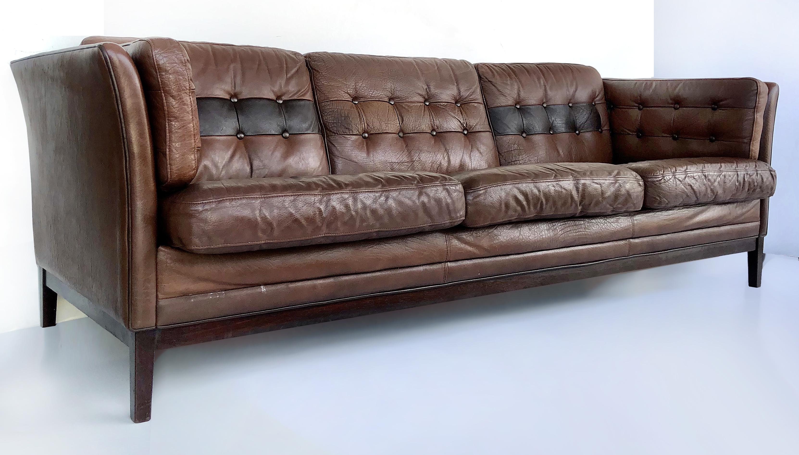 Scandinavian modern leather and rosewood sofa, 1970s

Offered for sale is an elegant and timeless 1970s Danish modern tufted leather and Brazilian rosewood sofa created in the manner of Borge Mogensen. The settee has 8 loose cushions that have a