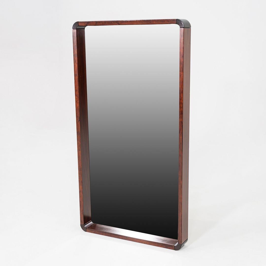 This is a Danish Modern mirror, produced in the 1970s. The piece features a rosewood frame with softly rounded edges. The elongated rectangular form and rich wood grain highlight the understated elegance of Danish design.

The mirror measures 27.5