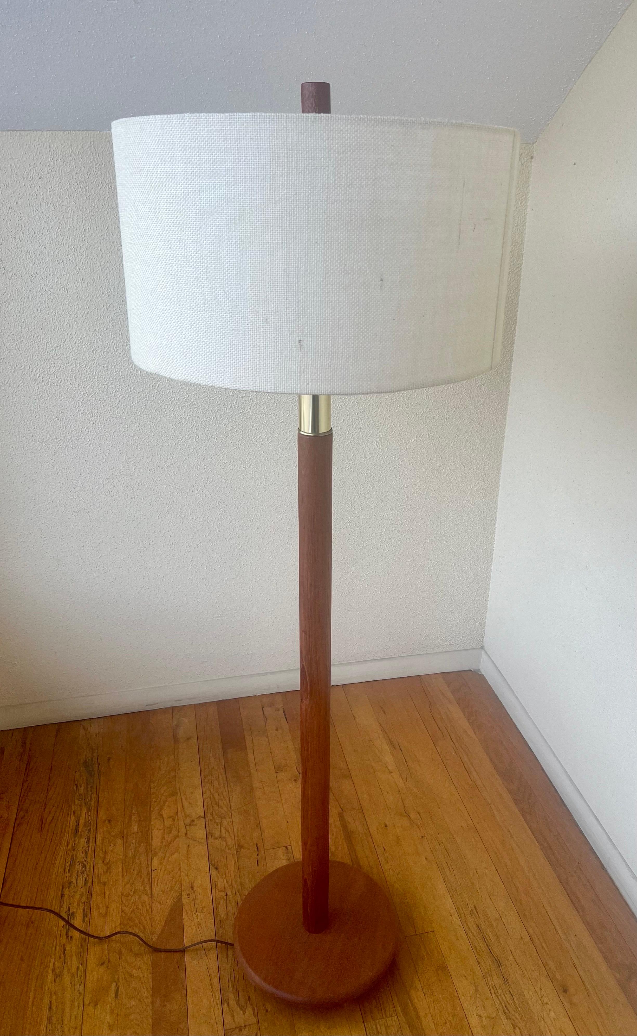 A pair of elegant solid teak and brass floor lamps,  freshly rewired, The lampshade is included and redone in burlap material, and the final is in solid teak everything its been restored including the wood, lampshade, and rewired, we have 2