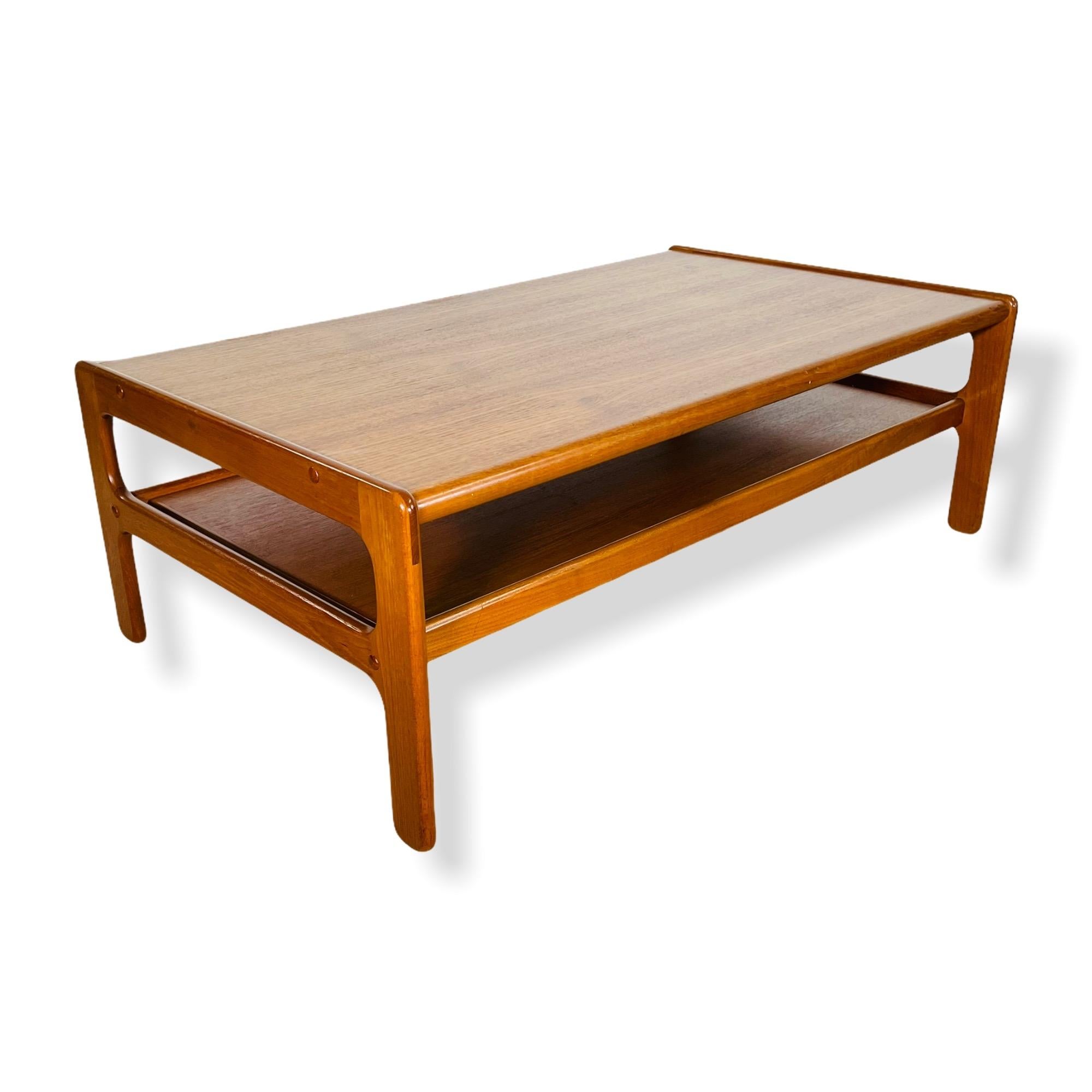 Here is beautiful mid-century Danish modern teak two tier coffee table designed by Kristensen & Thomassen for Moreddi of Denmark circa 1960s. This stunning table has the size, stance and built quality needed to complete you Mid-Century Modern living