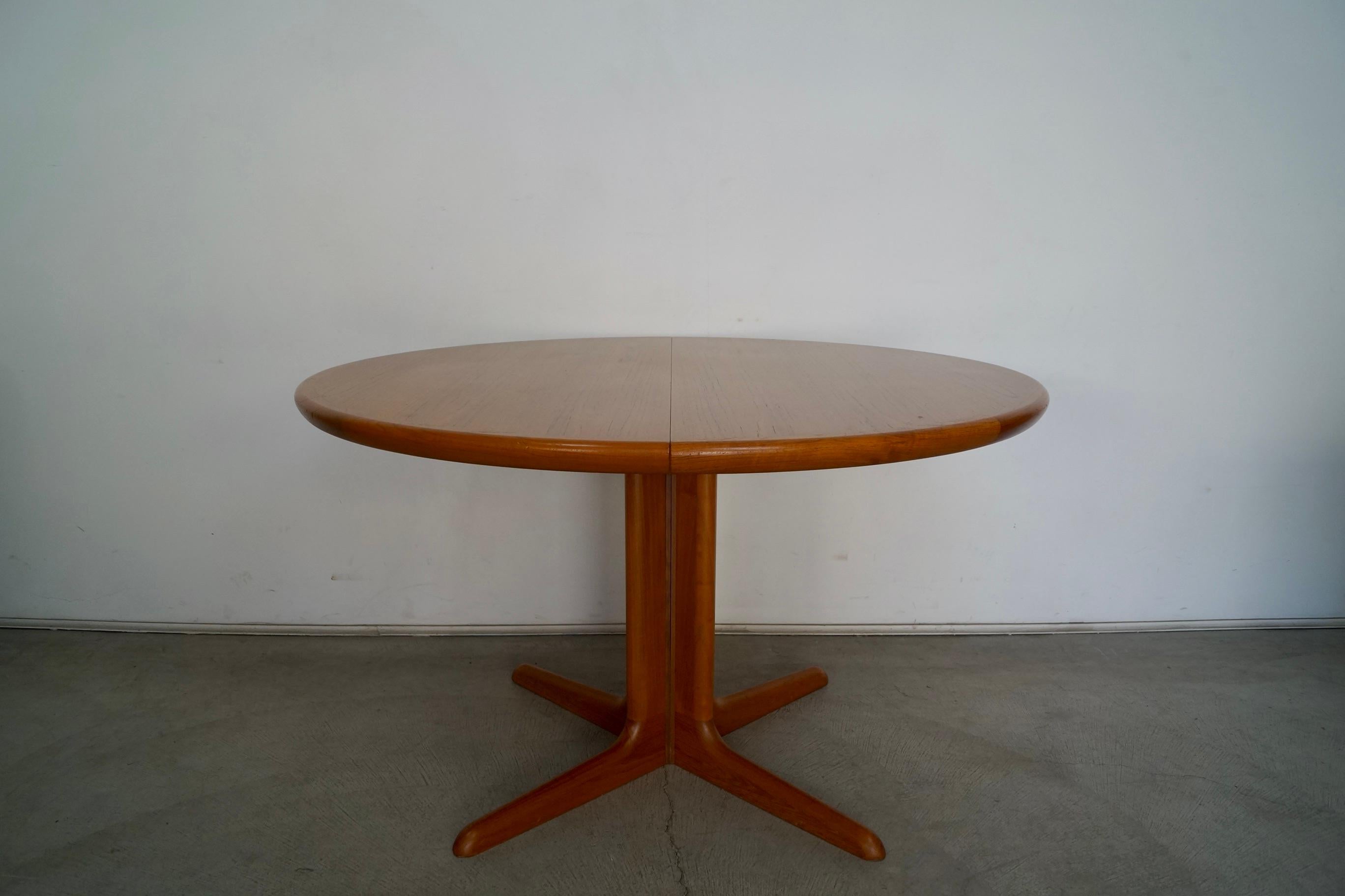 Original Mid-Century Modern dining table for sale. Manufactured in the 1970's by Skovby, and made in Denmark. Beautiful Scandinavian design in teak with solid teak legs. It's in great original condition with some soft wear to the top as shown. The