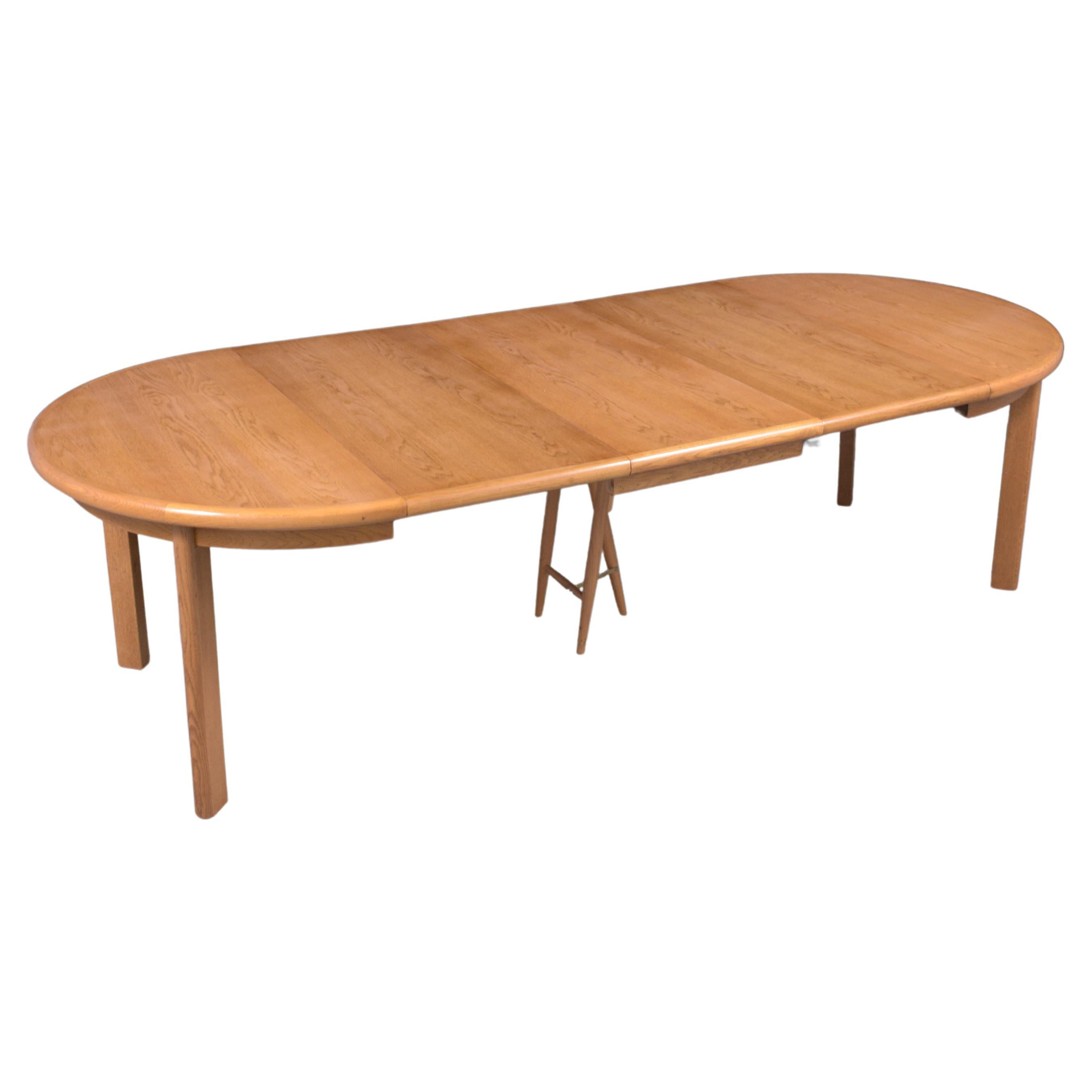 Introducing our stunning 1970s Danish Modern dining table, expertly crafted from teak wood and beautifully restored to pristine condition by our professional in-house craftsman team. This versatile table features a unique dual-shape design: circular