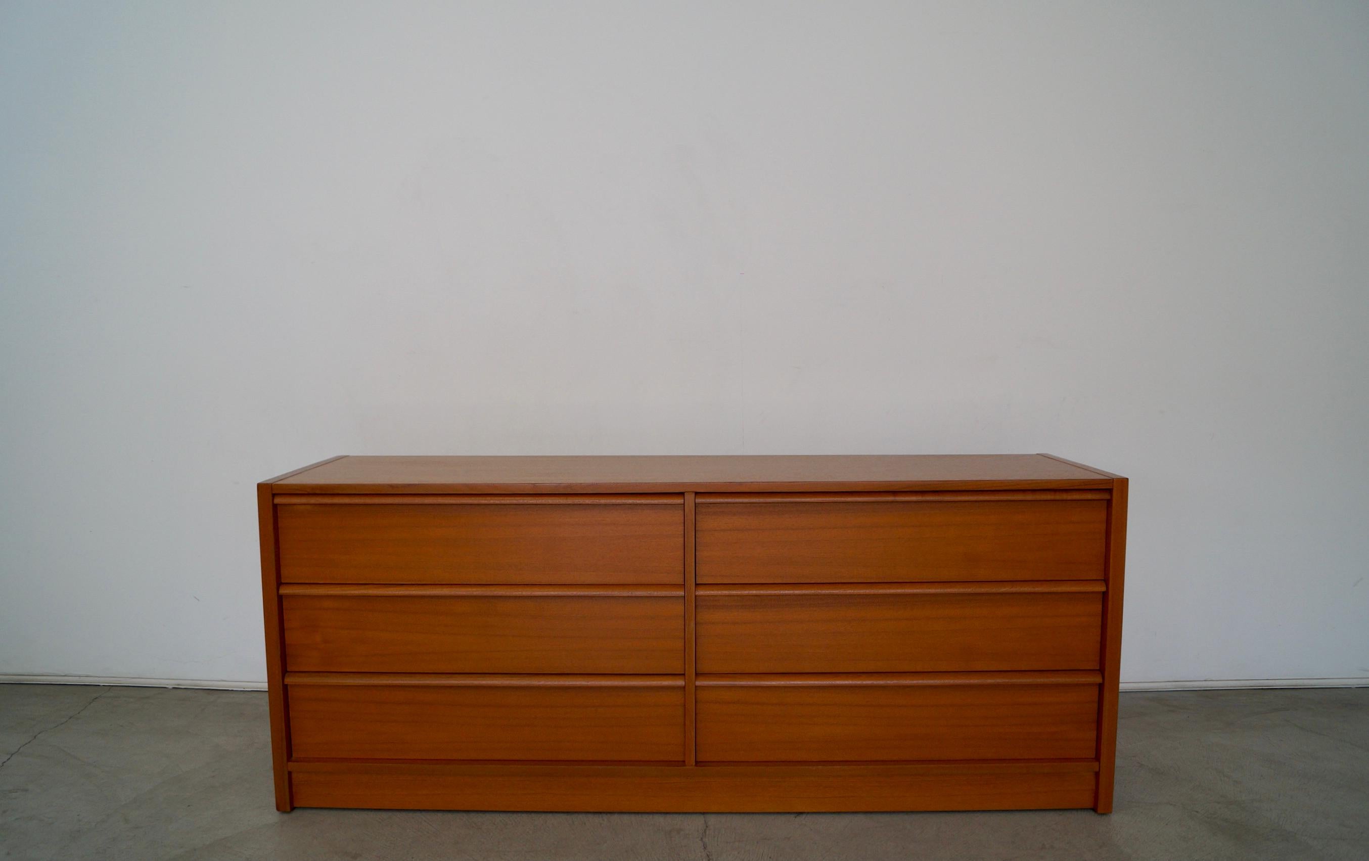 Vintage Mid-century Modern lowboy for sale. Manufactured in the 1970's, and was made in Denmark. It's made of teak, and has great solid construction. It has a clean design with the drawer pulls sculpted in the wood. All drawers are dovetailed on