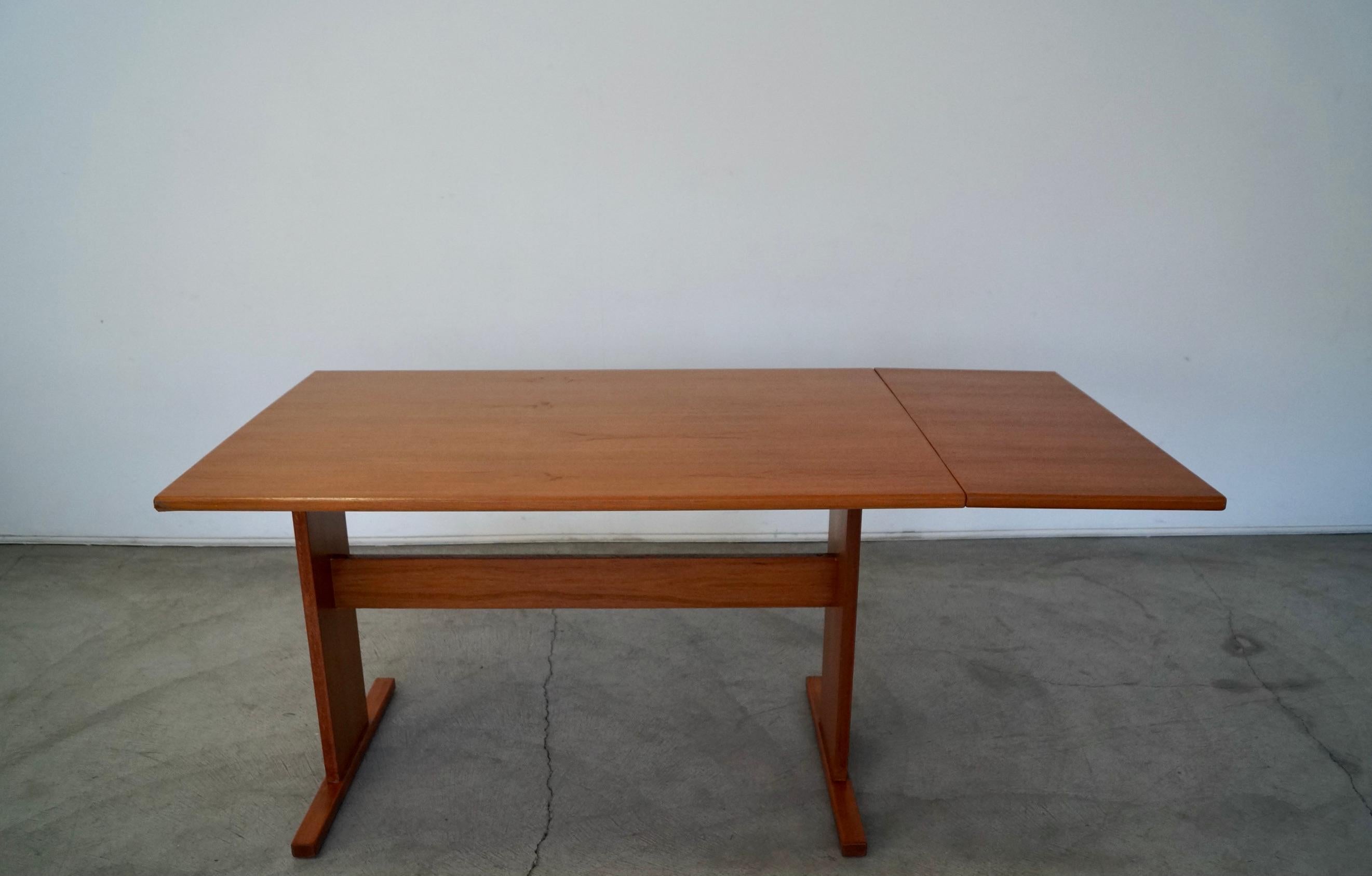 Vintage Mid-Century Modern dining table for sale. Manufactured in the 1970's by Gangso, and made in Denmark. Original Danish Modern piece, and made of teak. It has been professionally refinished and looks incredible. It has a nice clean design with