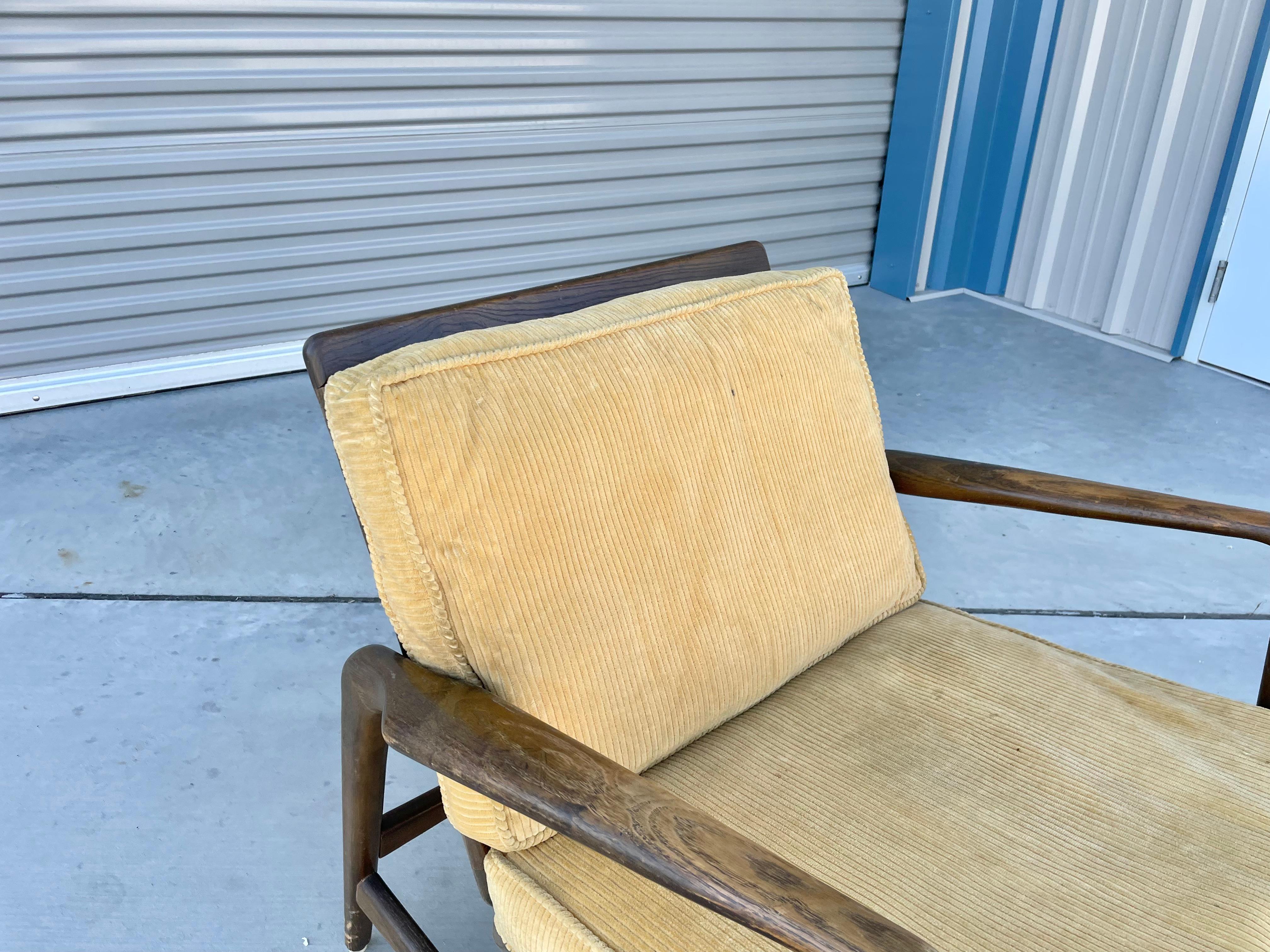 Mid-century teak lounge chair styled after Ib Kofod Larsen in Denmark circa 1960s. This beautiful lounge chair features a teak frame with yellow upholstery with a bit of age, but it can be used as-is, or you can have them reupholstered, giving you