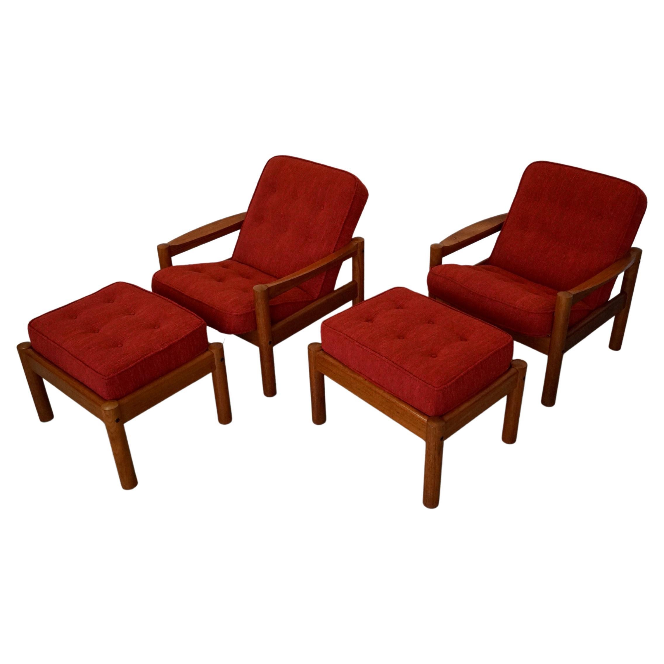 Pair of vintage Midcentury Modern lounge chairs for sale. They were manufactured in the 1970's, and have been professionally reupholstered in a nubby red fabric that is period correct. They have a solid teak frame, and come with a solid teak foot