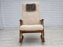 1970s, Danish rocking chair, reupholstered in quality genuine sheepskin.