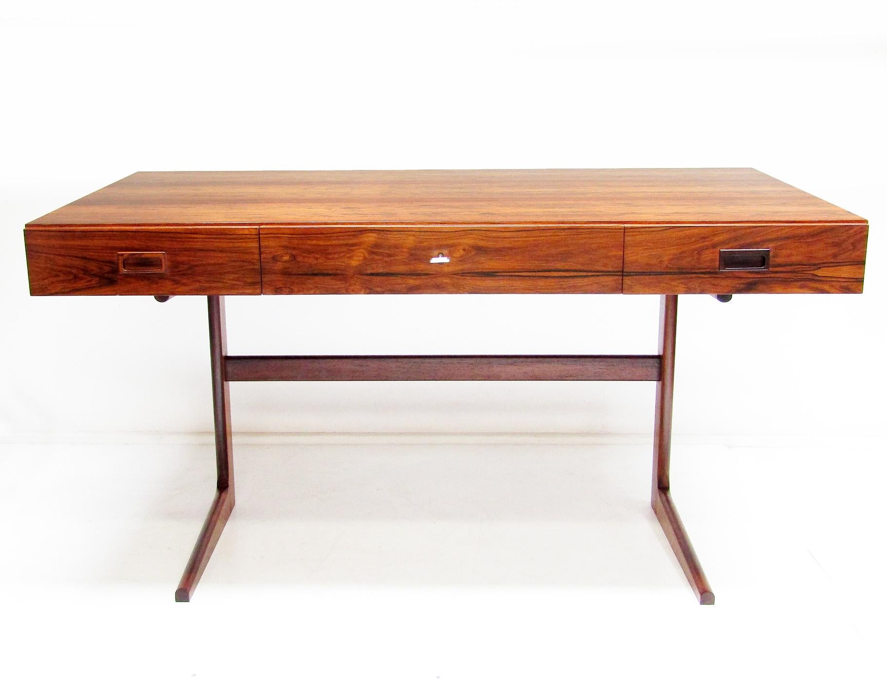 A stunning cantiliver desk in Rio rosewood by Danish designer Georg Petersens.

This sleek desk is similar in style to Nanna Ditzel or Bodil Kjaer's iconic designs.

The rosewood veneer is in excellent condition. The figuring continues through