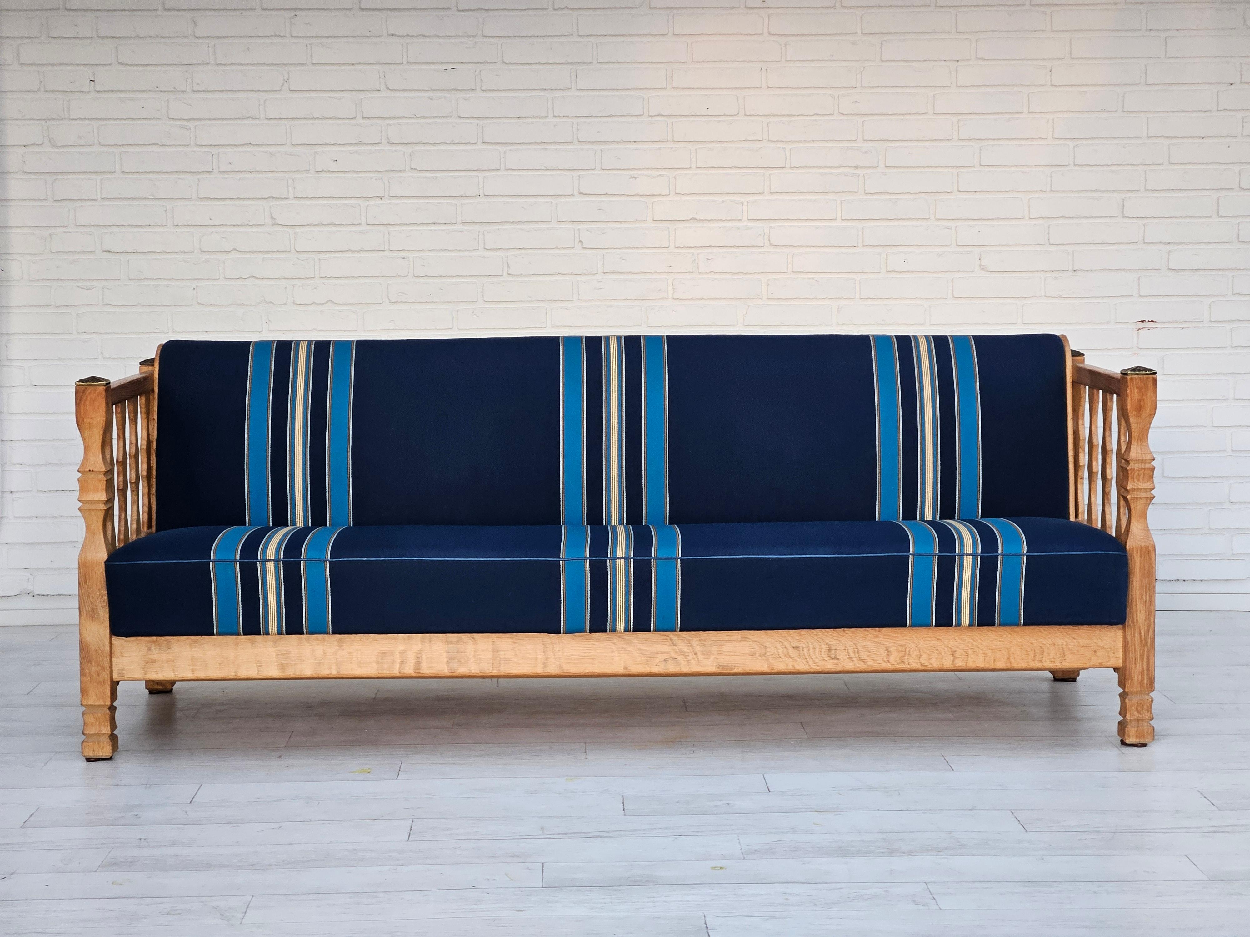 1970s, Danish sleeping foldable sofa. Original very good condition: no smells and no stains. Furniture wool fabric in blue color. Can be put in duvet, pillows, etc. Solid oak wood, springs in the seat and back. Manufactured by Danish furniture