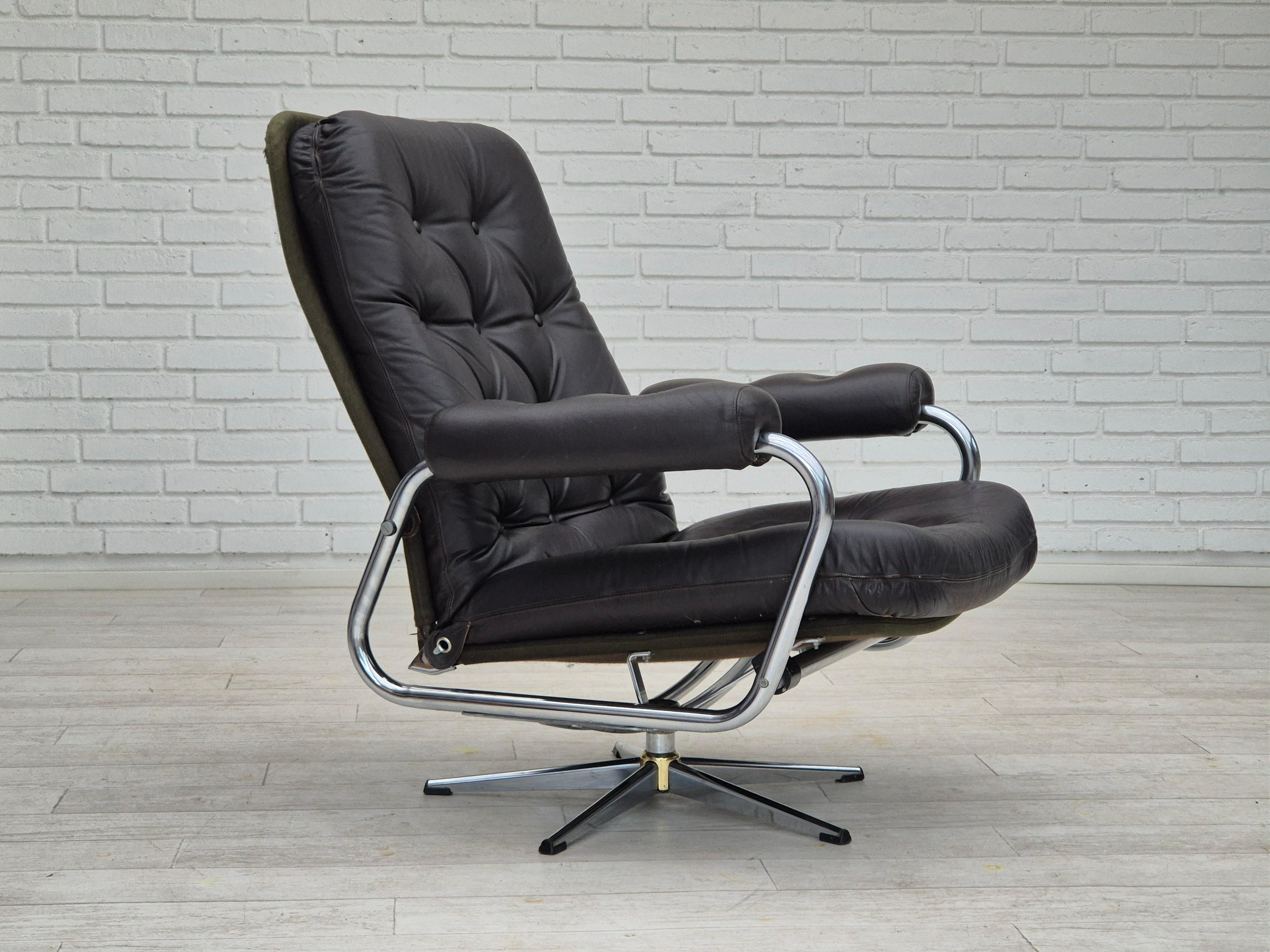 1970s, Danish swivel chair in original good condition: no smells and no stains. Adjustable seat with backrest. Brown leather, chrome steel, canvas. Manufactured by Danish furniture maker in about 1970-75.