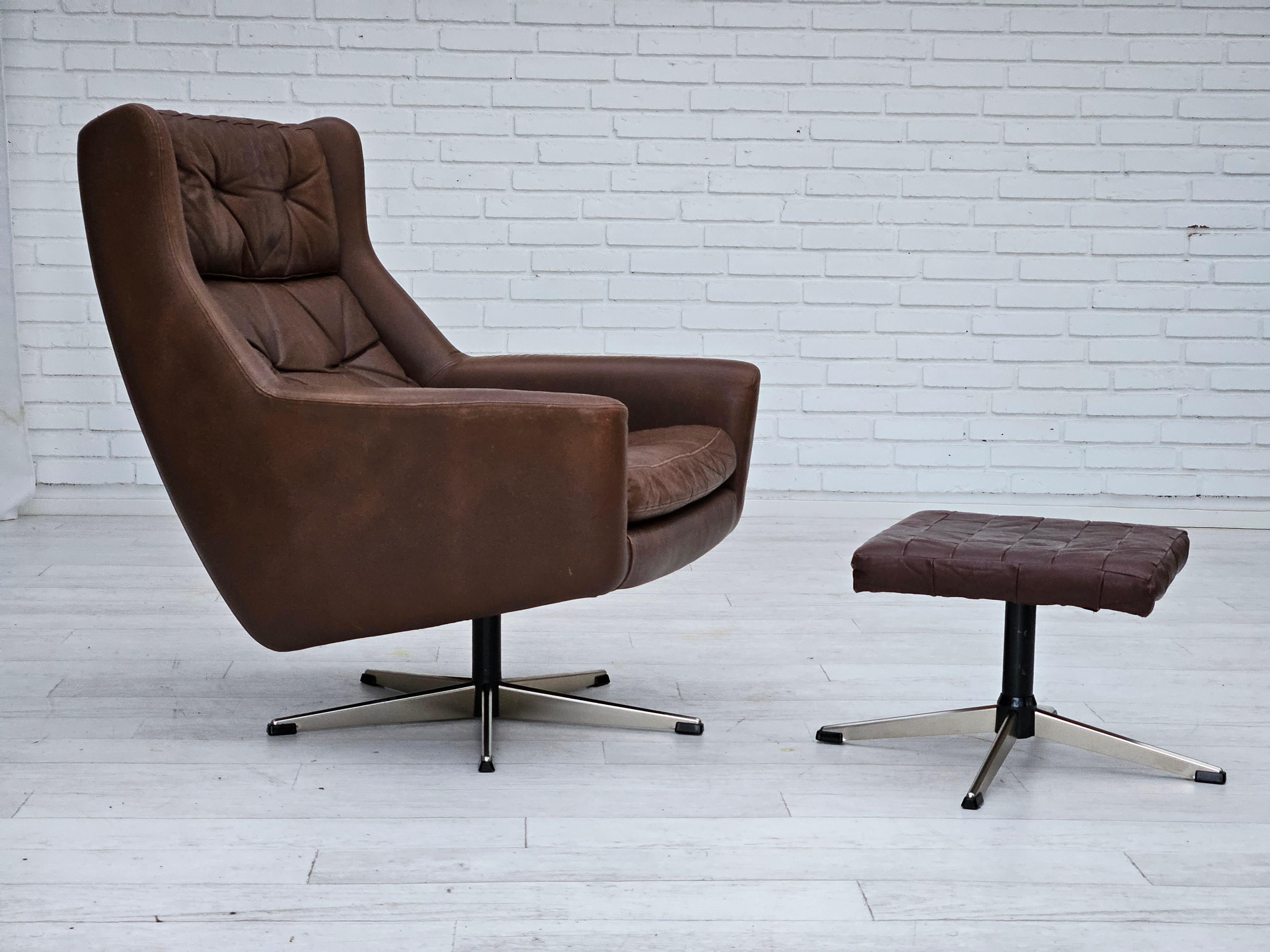 1970s, Danish swivel chair with footstool in original good condition: no smells and no stains. Brown leather, chrome steel base. Removable cushions. Manufactured by Danish furniture manufacturer in about 1970s.