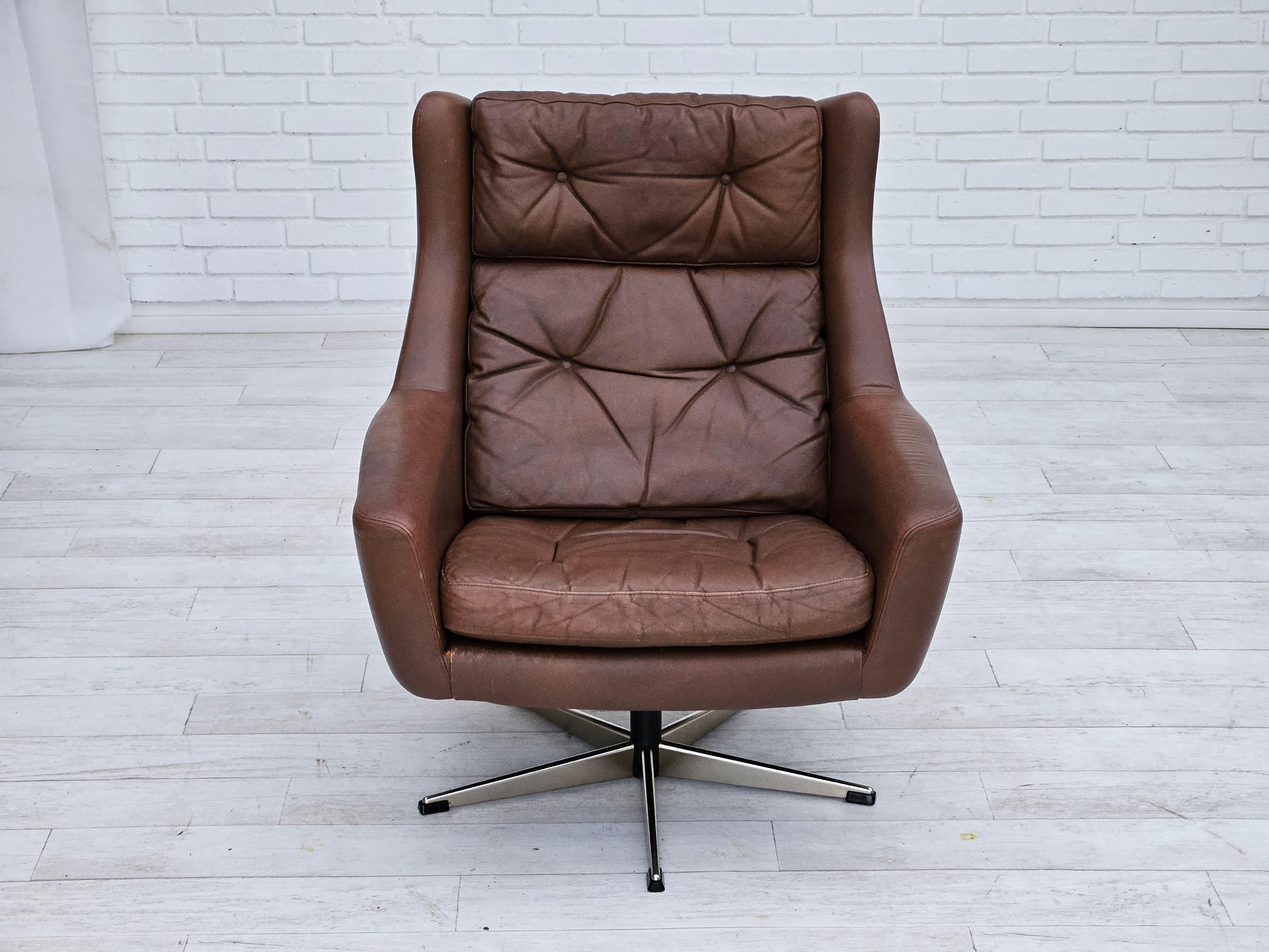 Late 20th Century 1970s, Danish swivel chair with footstool, original good condition, leather. For Sale