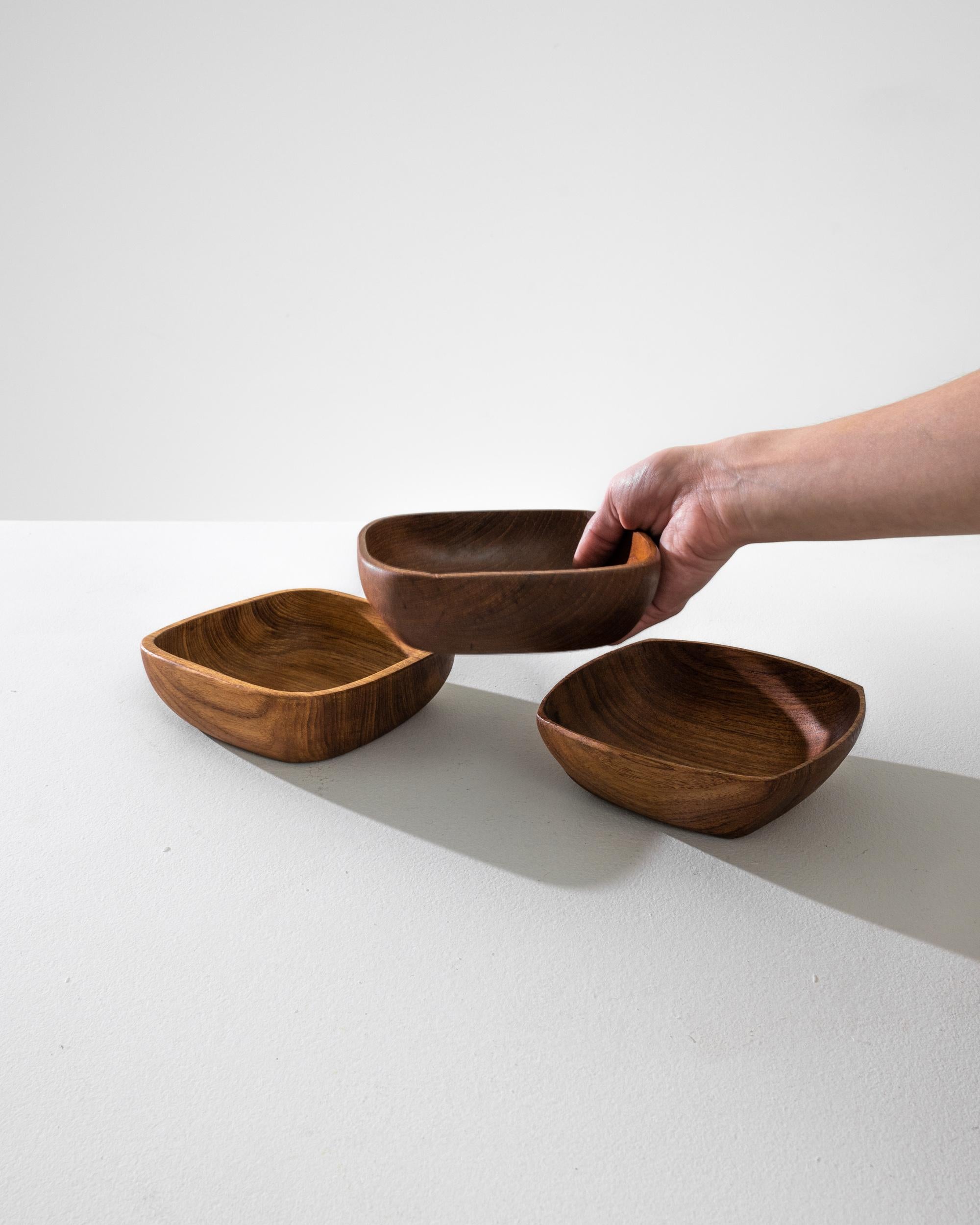 Immerse in the elegance of Danish design with this 1970s teak bowl, a piece that exemplifies the minimalist and functional ethos of the era. Each bowl, sold individually, is a testament to the beauty of simplicity, crafted from exquisite teak with a