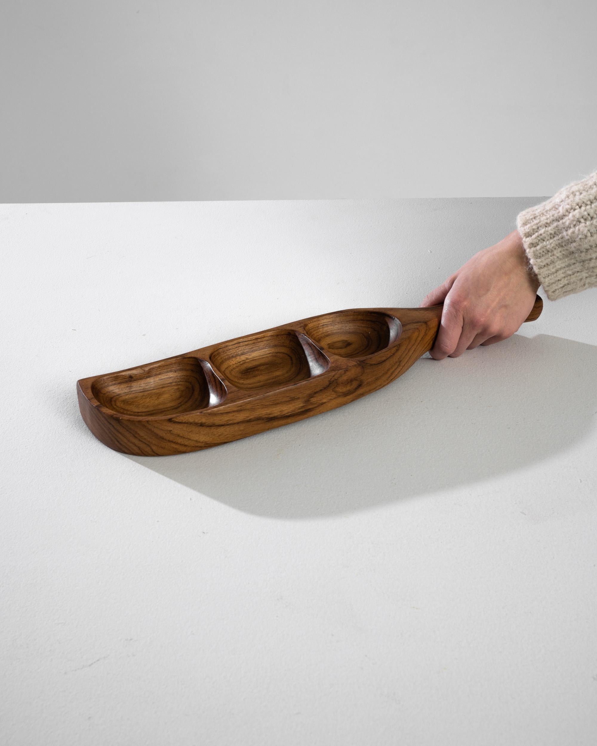 Embrace the timeless elegance of Danish design with this exquisite 1970s Teak Bowl, a piece that marries functionality with art. Crafted from the finest teak wood, renowned for its durability and warm, rich hues, this bowl features a trio of