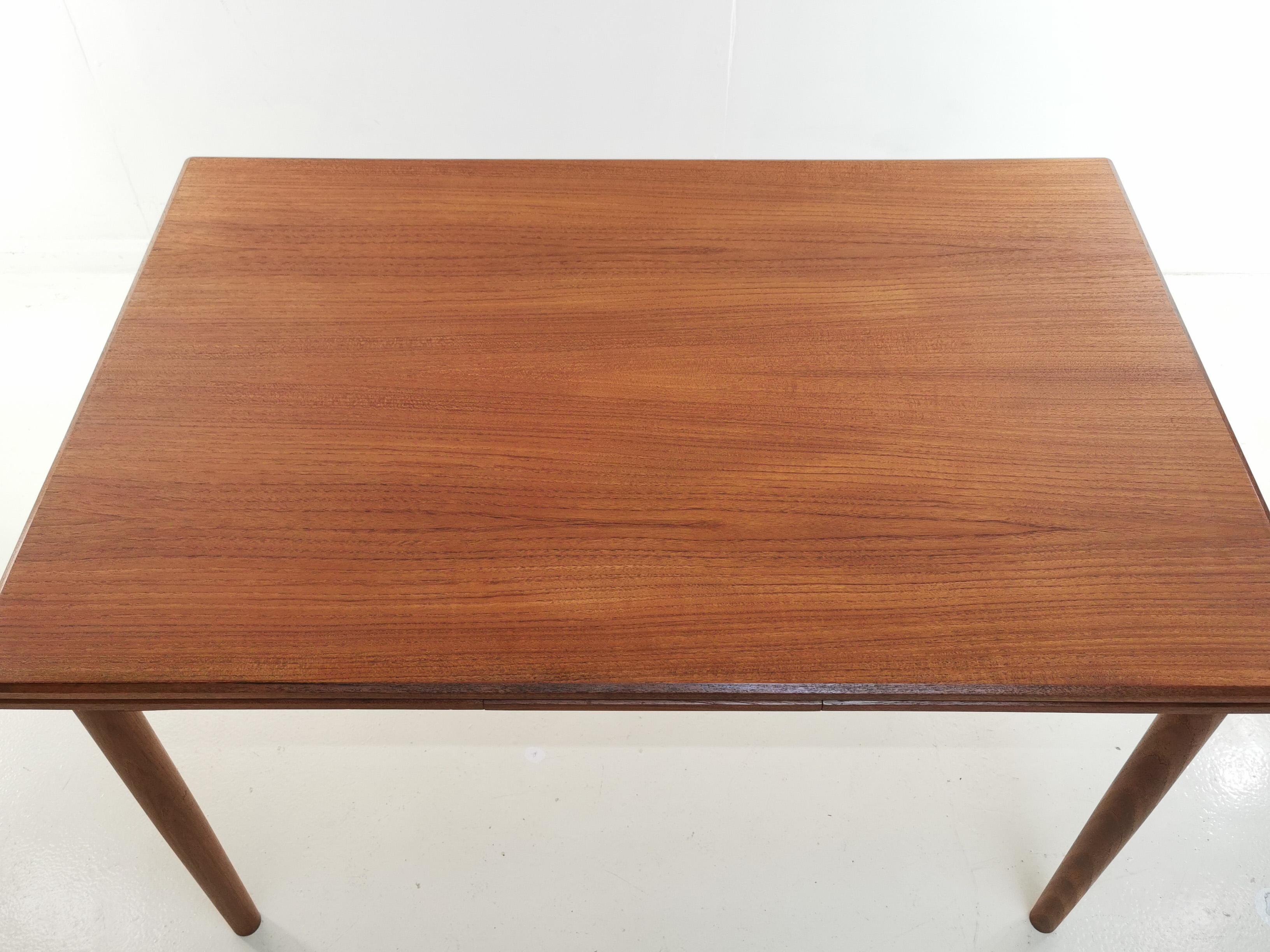 Danish teak extending dining table

Midcentury teak Danish extending dining table by Clausen and Son. 

An excellent example, in superb condition. All parts are running smooth. 

Simple, with clean lines and a practical quality made dining