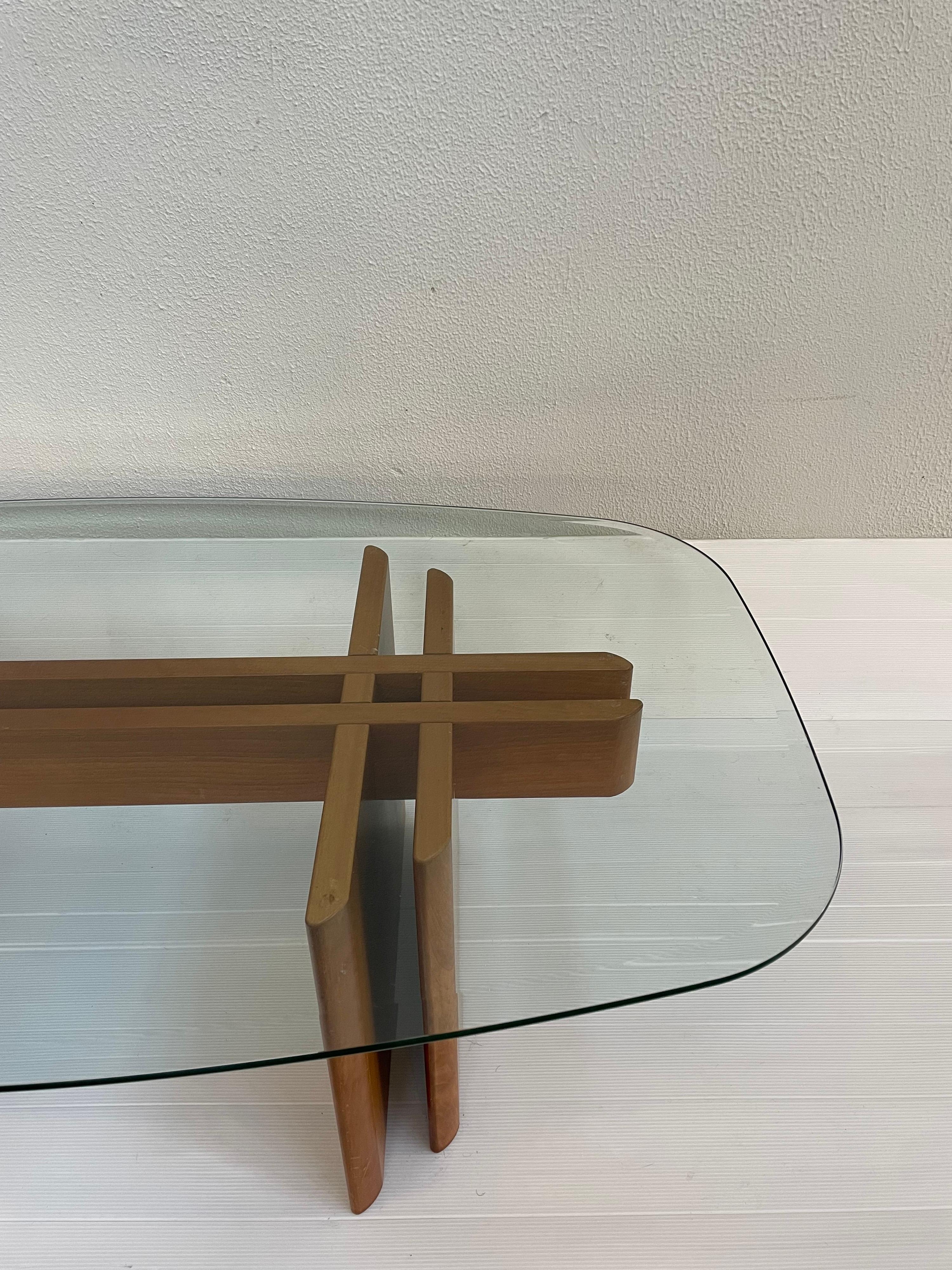 Vintage 1970s teak table by Gustav Gaarde for Trekanten of Denmark. The glass top which has a 3/8 inch bevel, rests on an interlaced teak base. 1 out of 3 pieces of a set listed.