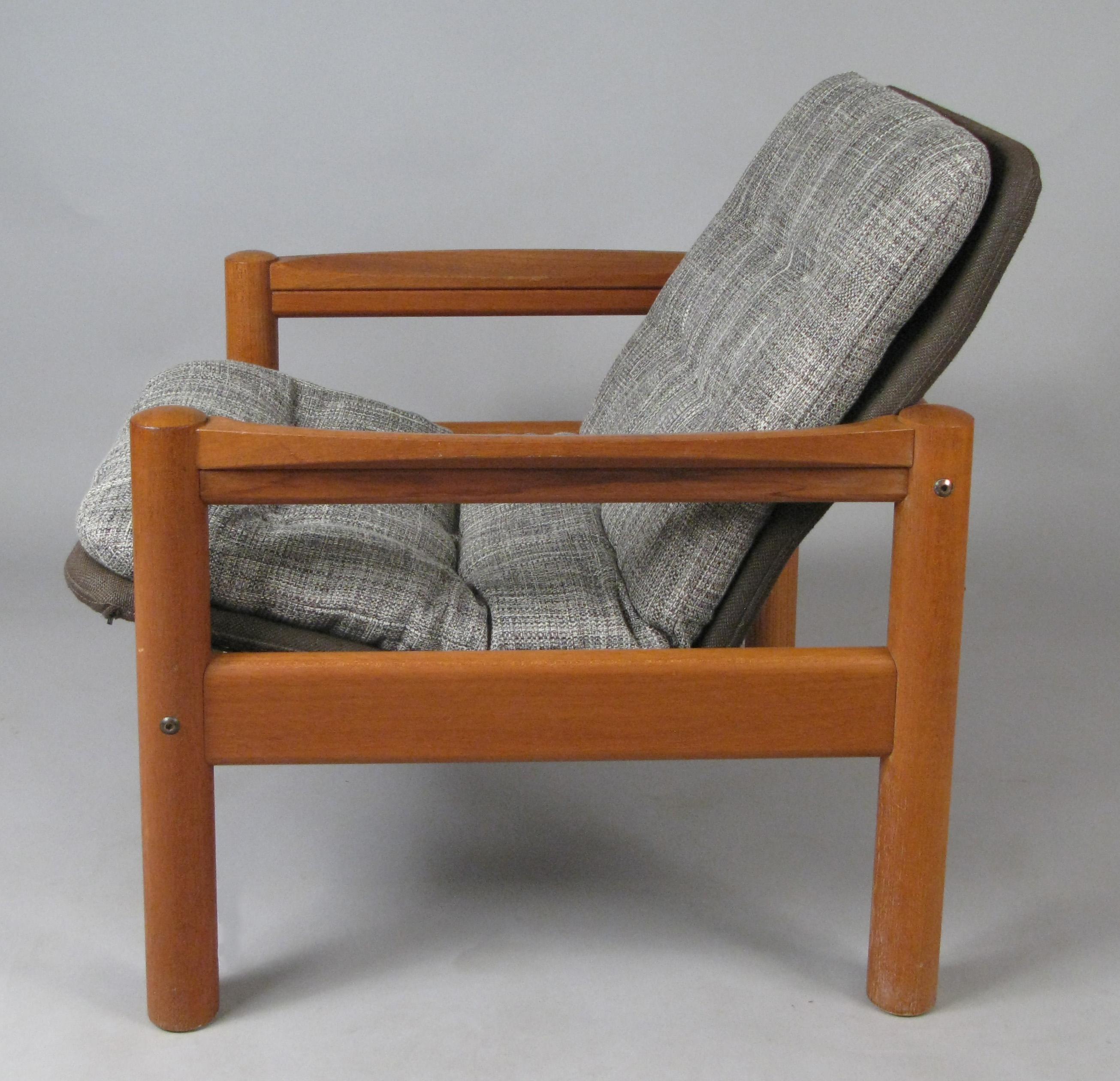 A very handsome solid teak vintage 1970s lounge chair made by Domino Møbler. With its original brown linen covered seat frames and newly upholstered button tufted seat covers in a woven grey and cream. This listing is for the lounge chair.