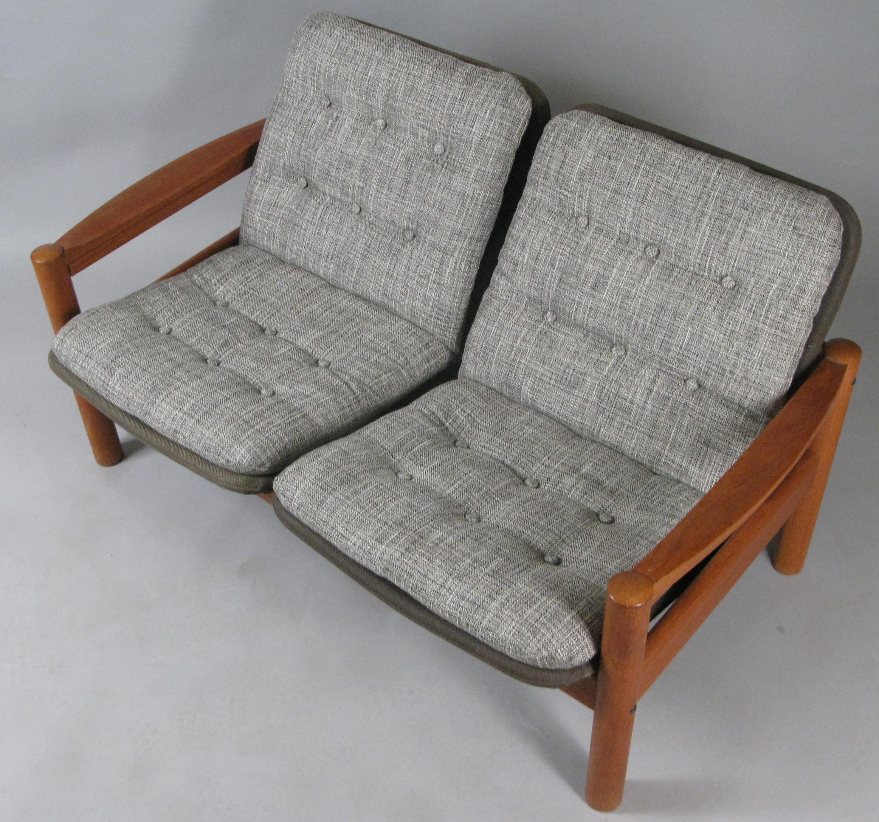 A very handsome solid teak vintage 1970s two-seat settee made by Domino Mobler. With it's original brown linen covered seat frames, and newly upholstered button tufted seat covers in a woven grey and cream. Very stylish and comfortable. This listing