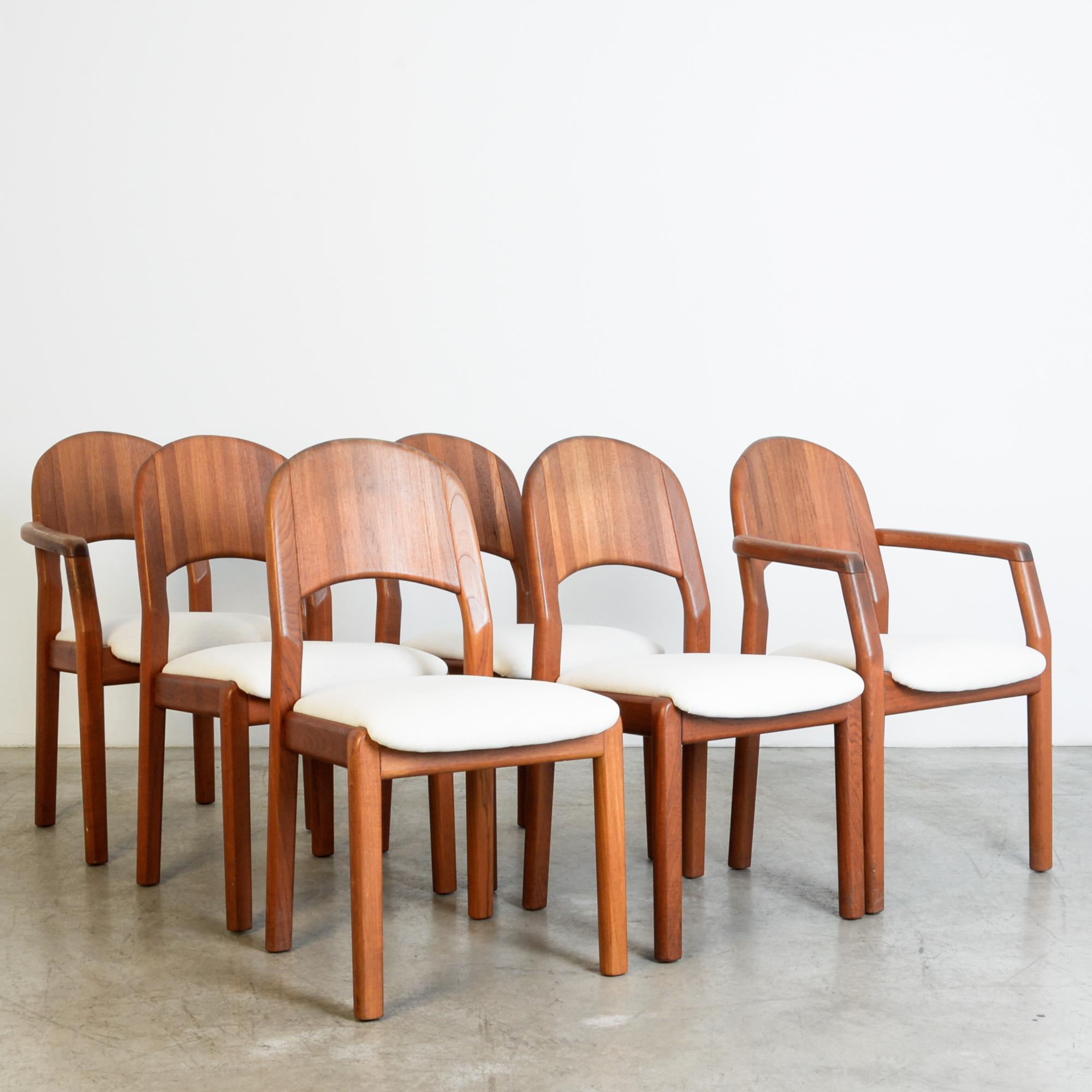 A geometric hardwood dining chair set in characteristic mid-20th century modernist style. Simple and sturdy forms combine dynamically, at angles with reclining back and supportive legs. The re-upholstered seat echoes the shape of a unique solid wood