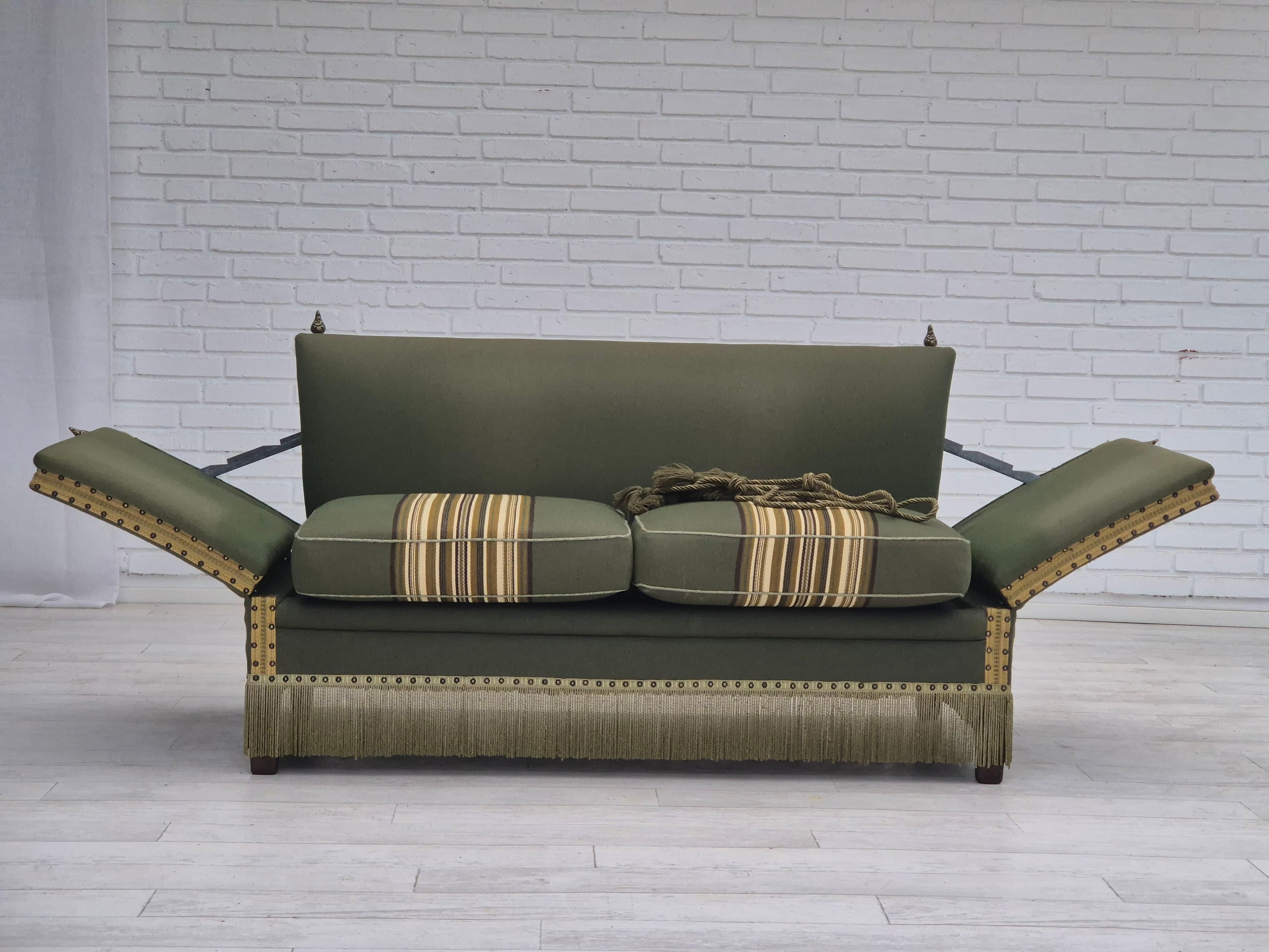 1970s, Danish 2 seater drop arm sofa in original very good condition: no smells and no stains. Green furniture wool, beech wood legs Adjustable armrests (adjustment lever under the back sofa). Decorative cords for adjusting armrests. Manufactured by