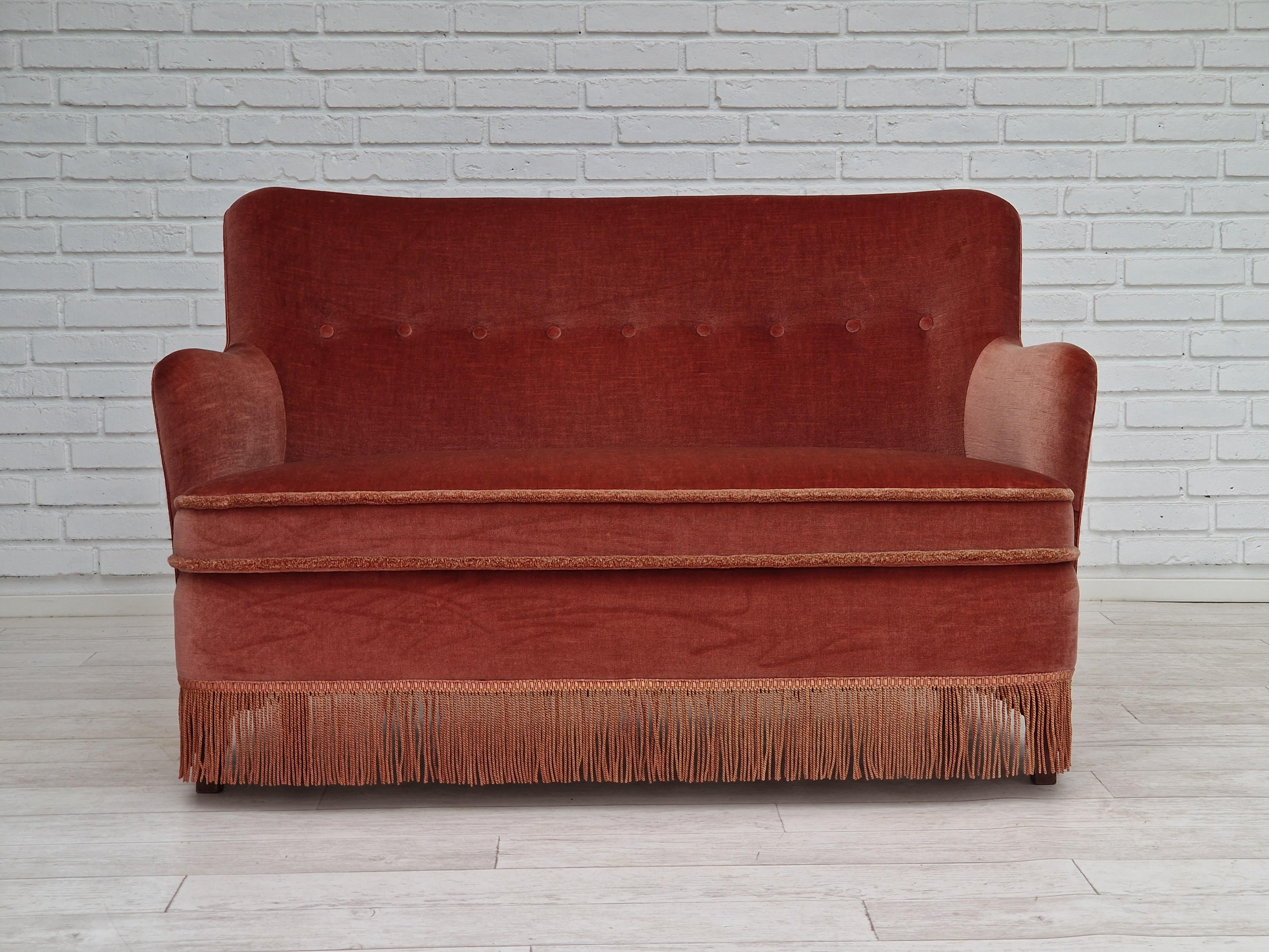 1970s, Danish design. Little 2 seater sofa. Original upholstery in light red velour with nice patina, very good condition. Beech wood legs, springs in the seat. No smells, no stains. Made in about 1970 by Danish furniture manufacturer.