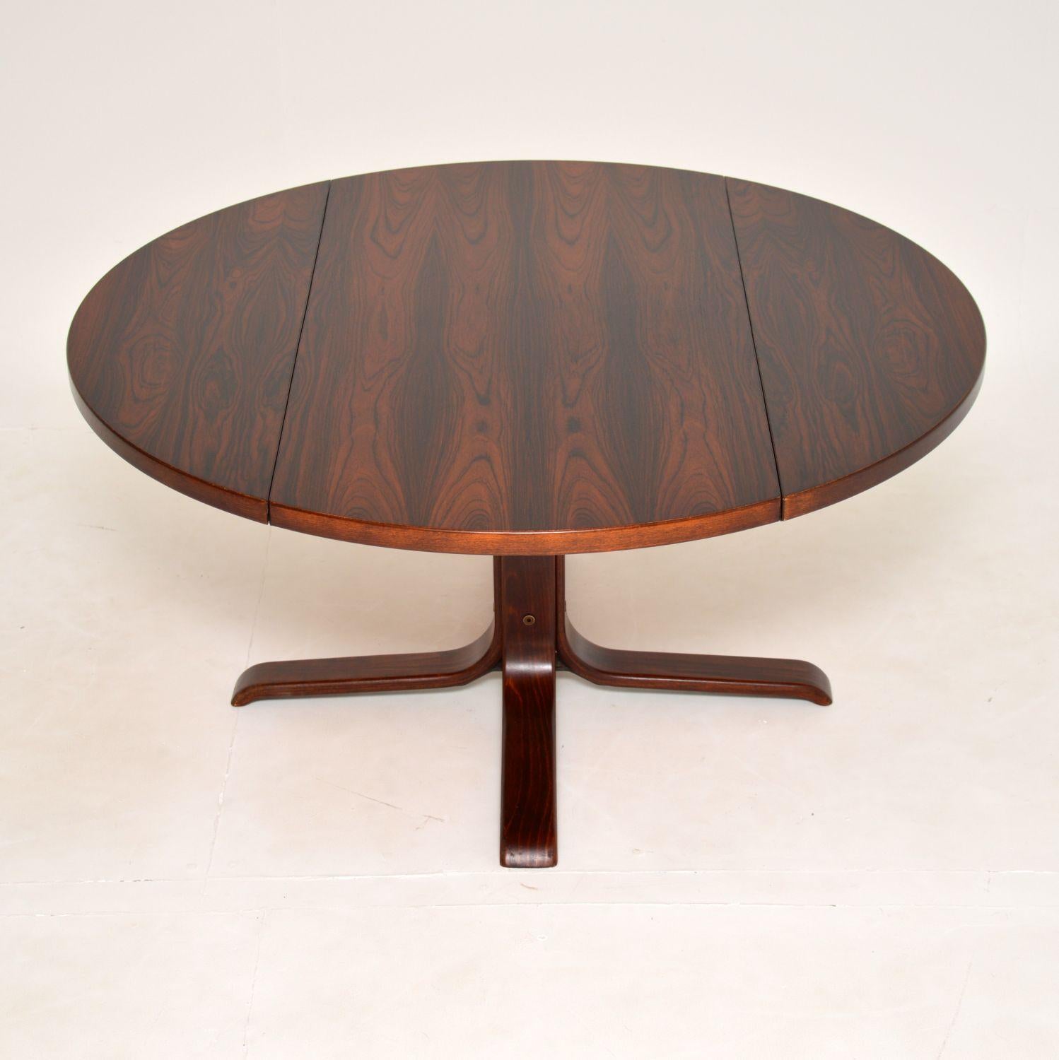 A stylish and very unusual Danish drop leaf coffee table in wood. This was made in Denmark, it dates from the 1970’s.

It is of superb quality and has a very large surface area for a coffee table. The two ends of the top can drop down to reduce
