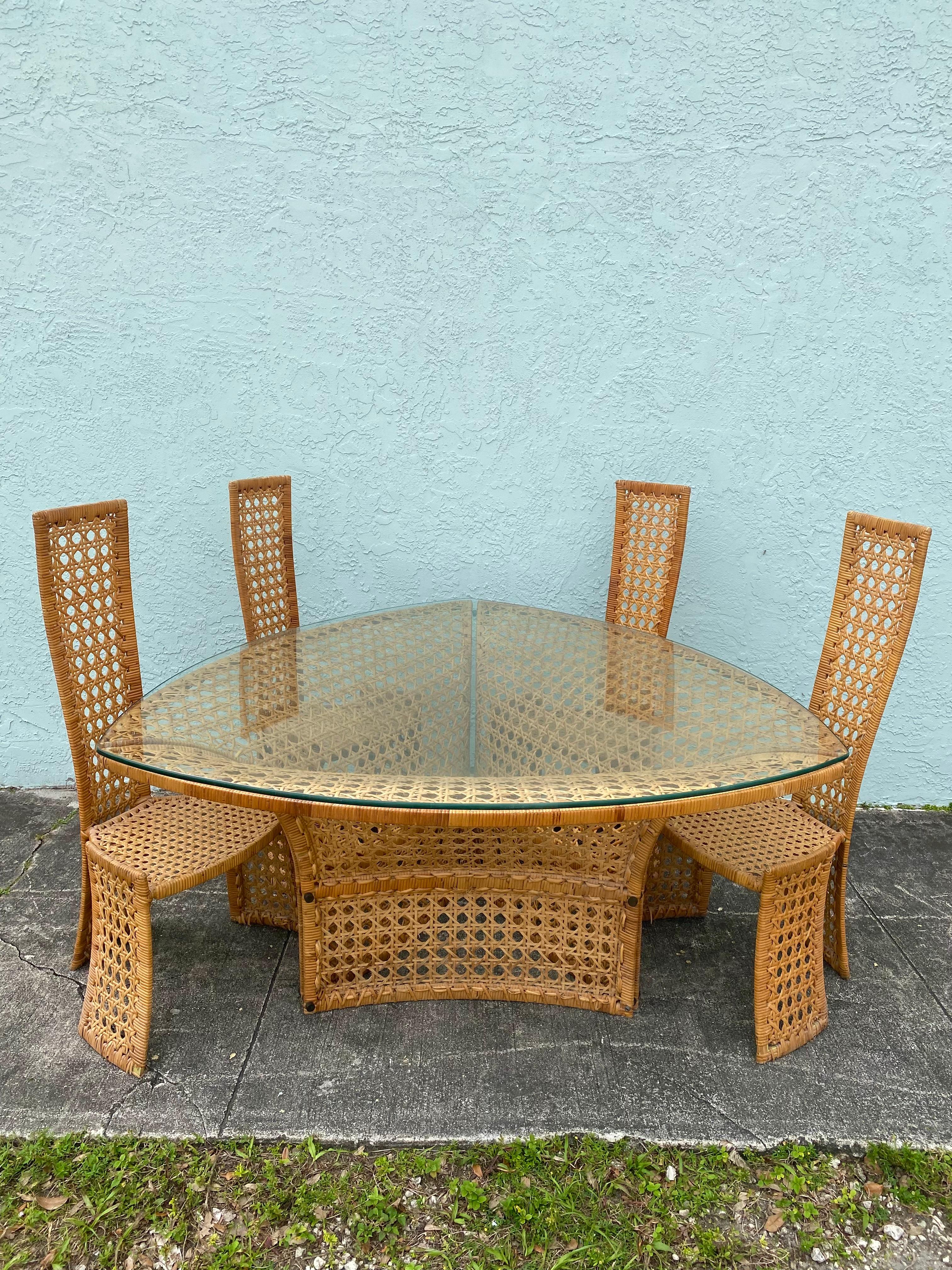 On offer on this occasion is one of the most stunning and rare, rattan dining table and chairs set you could hope to find. In its original organic condition. No restoration. Outstanding design is exhibited throughout. The beautiful set is statement