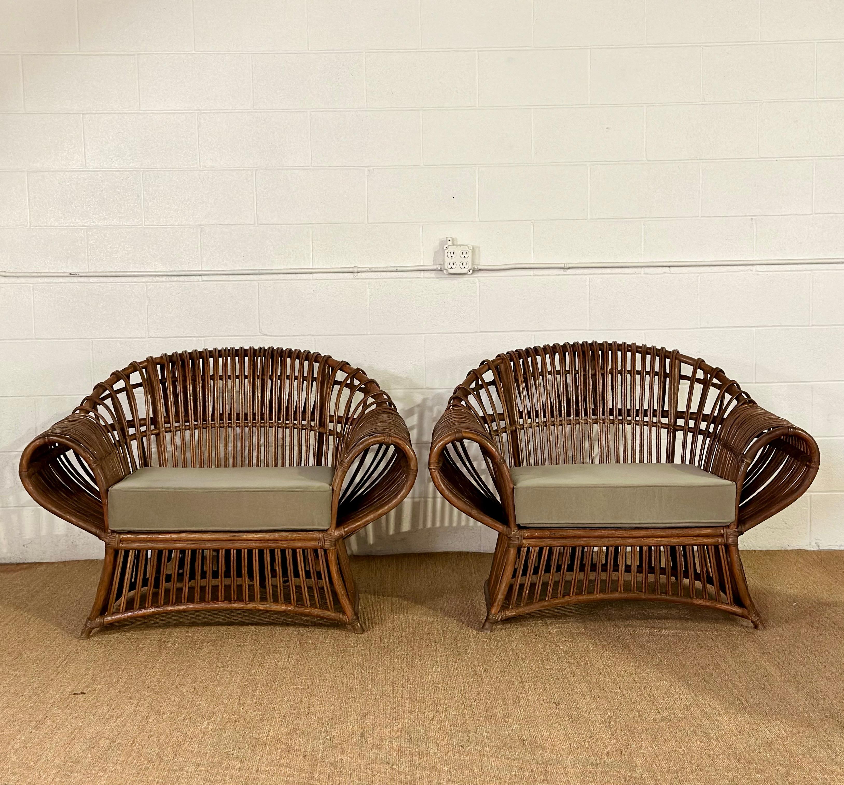 We are very pleased to offer a unique pair of beautiful lounge chairs, circa the 1970s.  Crafted with solid rattan, this pair exudes a timeless organic aesthetic, showcasing meticulous handwoven construction that speaks to artisanal craftsmanship. 