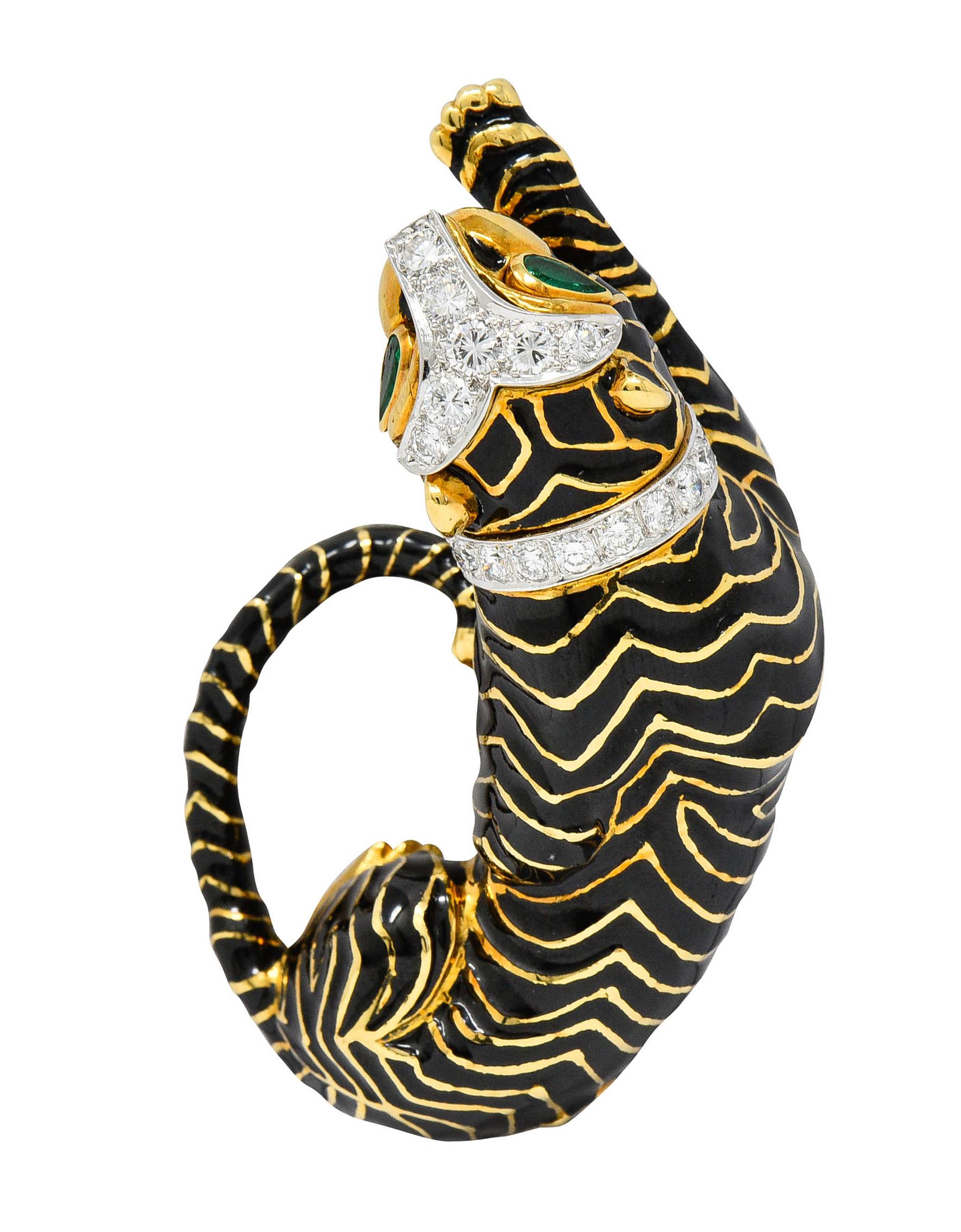 Statement brooch is designed as a languid tiger with an eager outstretched paw

Glossed with black enamel stripes that exhibit very minor loss

Its eyes are bezel set pear cut emeralds that weigh in total approximately 0.25 carat - bright