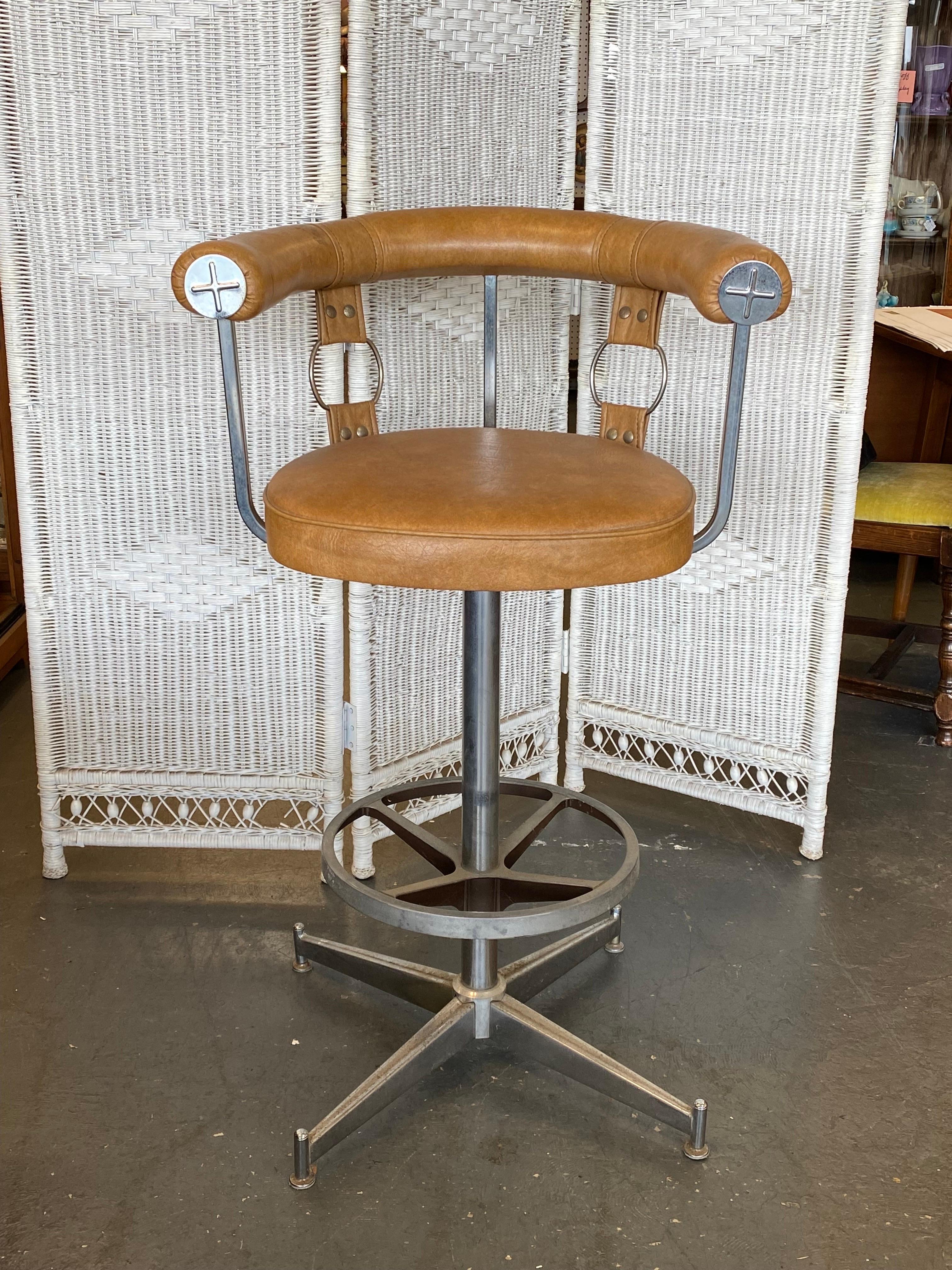 Cool 1970's caramel colored faux leather or vinyl covered bar stool with chrome accents. This bar stool was made in the USA by the Daystrom Furniture Company. 

This is a cool piece of 1970's furniture that will look awesome wherever