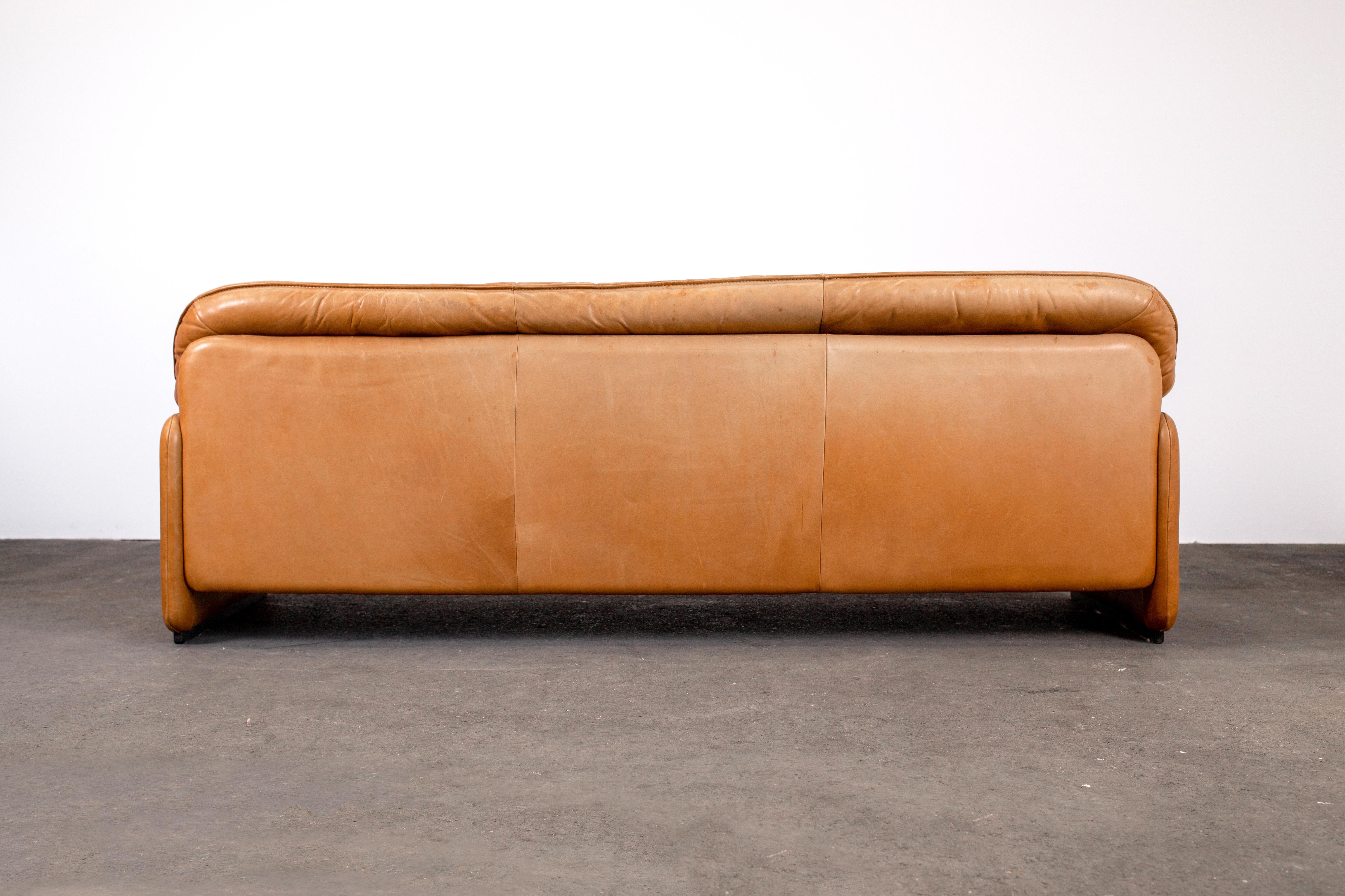 1960s Mid Century Modern 3 seat De Sede model DS-61 sofa. Hand made in Switzerland by renowned seating designer and manufacturer, De Sede.

This stunning example features high quality thick cognac-colored vegetable tanned leather upholstery with