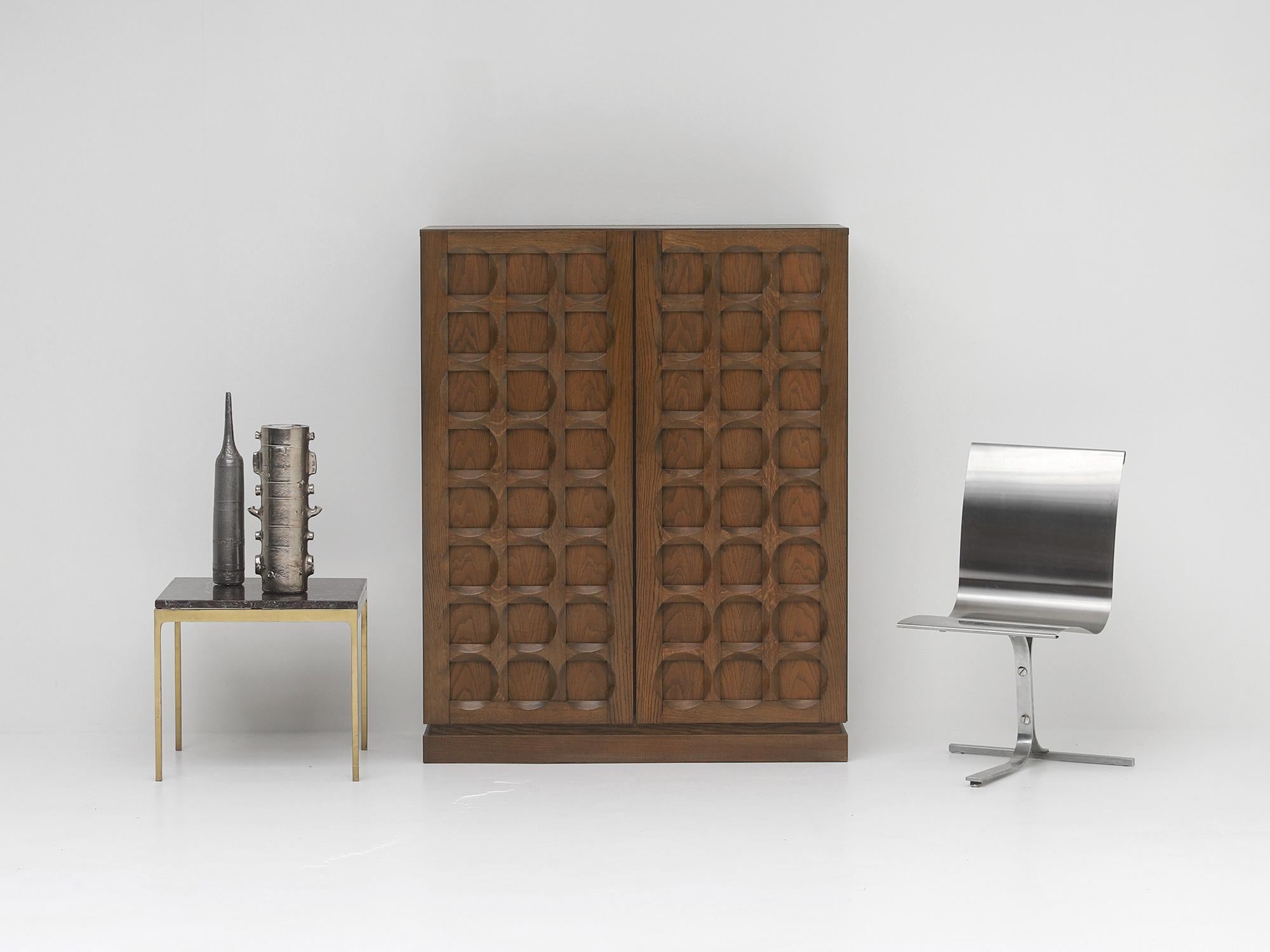 Graphical cabinet made out of oak, designed and built in the 1970s by Defour, Belgium. Defour was based in Hooglede and runned by the brothers Frans and Herman Defour. They had a progressive style of furniture design which the company received