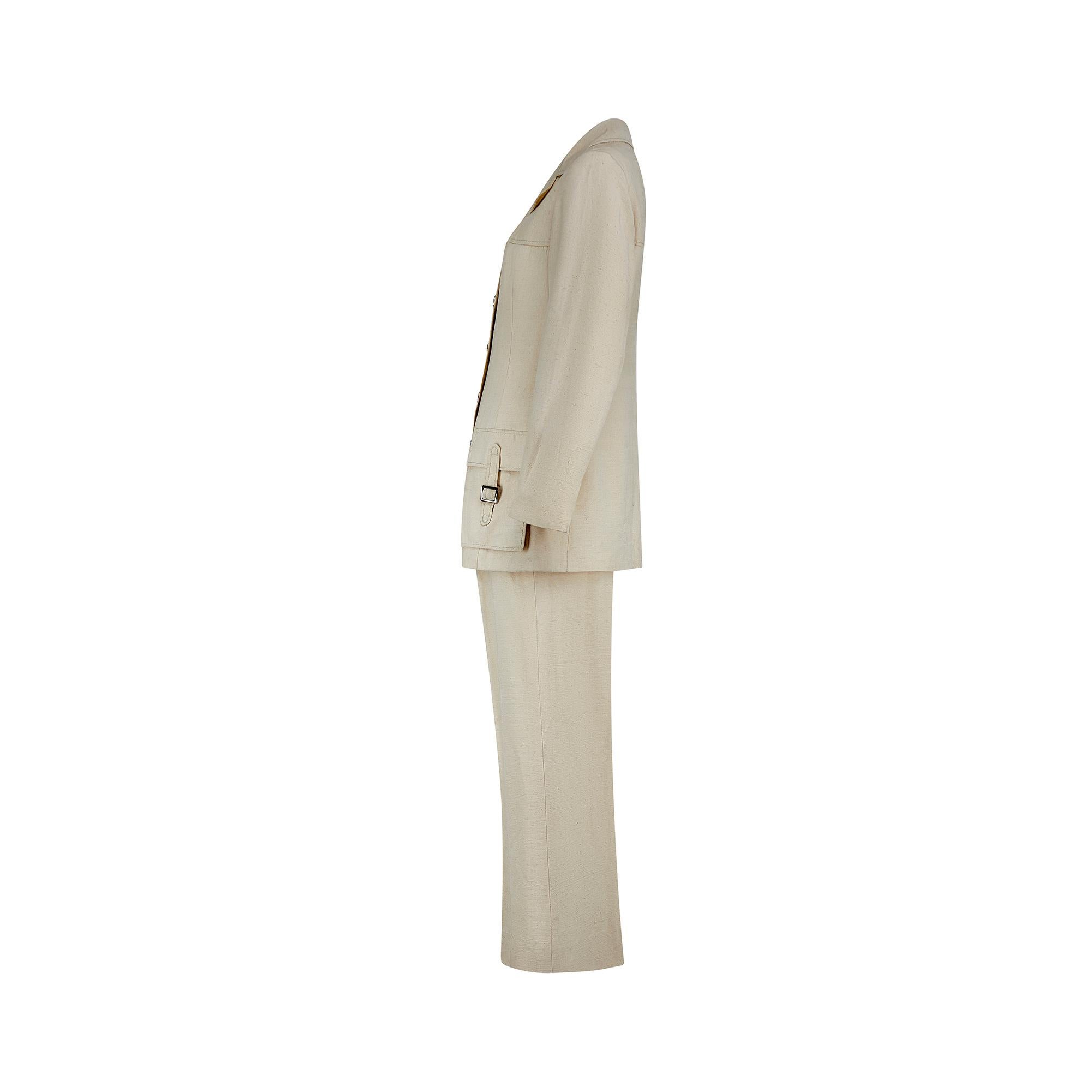 This two-piece, couture-made trouser suit was designed in the 1970s and were popularised by luxury French designers Ted Lapidus and Yves Saint Laurent. Drawing on the safari styling that was so in vogue during this era, it features wide lapels,