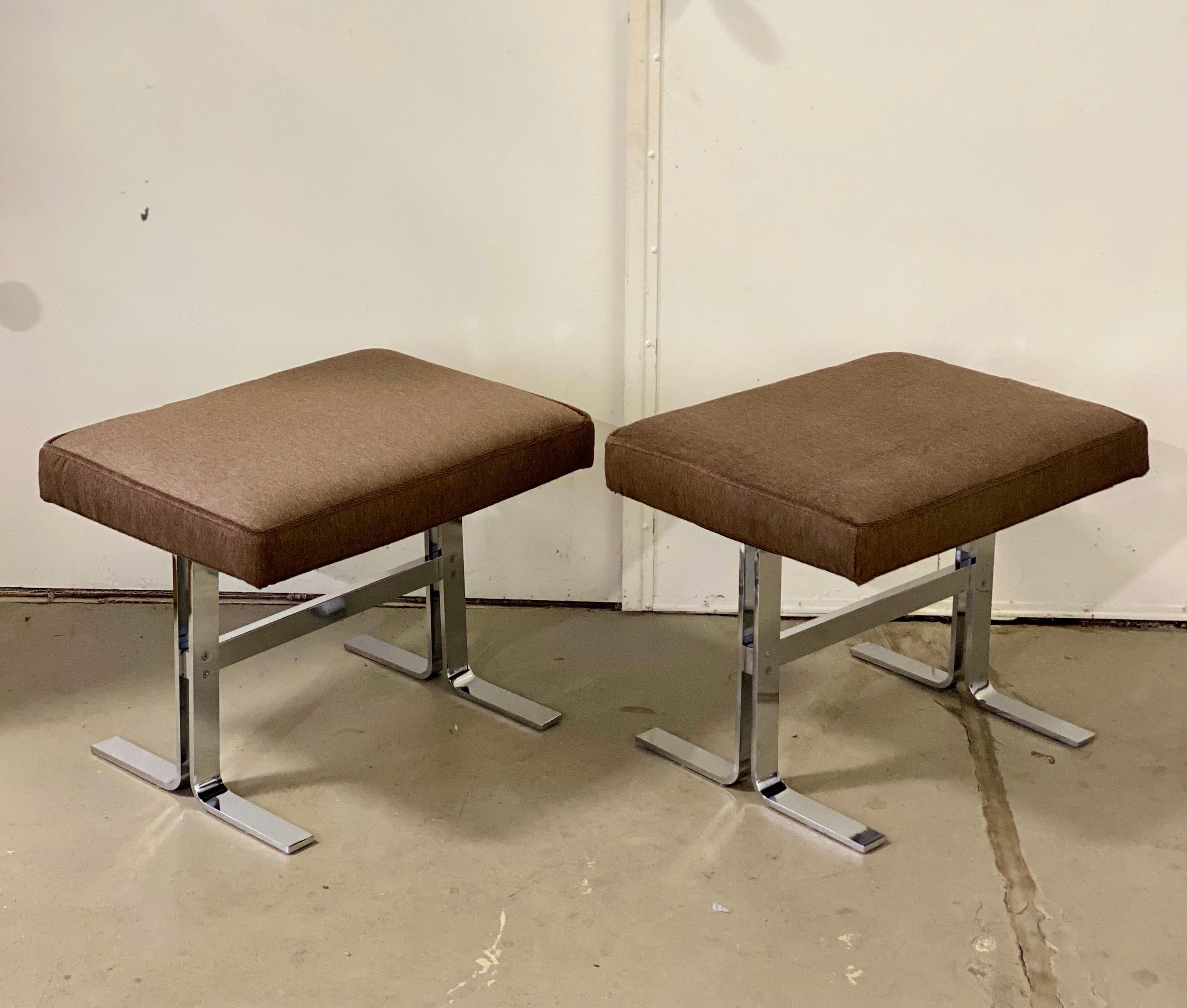 We are very pleased to offer a pair of sophisticated ottomans by the Design Institute of America, circa the 1970s. Featuring a clean Silhouette, these beautiful ottomans showcase sturdy, polished chrome finish bases paired with new upholstered seats