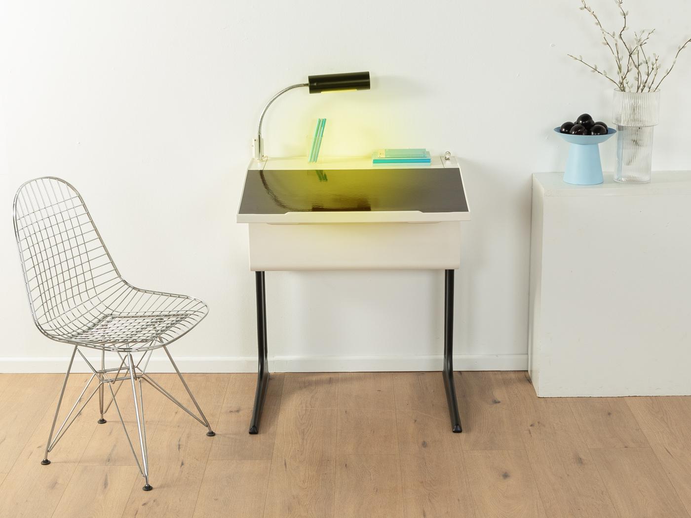 Space age desk from the 1970s by Flötotto. The design is attributed to the Italian designer Luigi Colani. Corpus and height-adjustable plastic frame with a hinged writing surface and the original Flötotto lamp.

Quality Features:
    very good