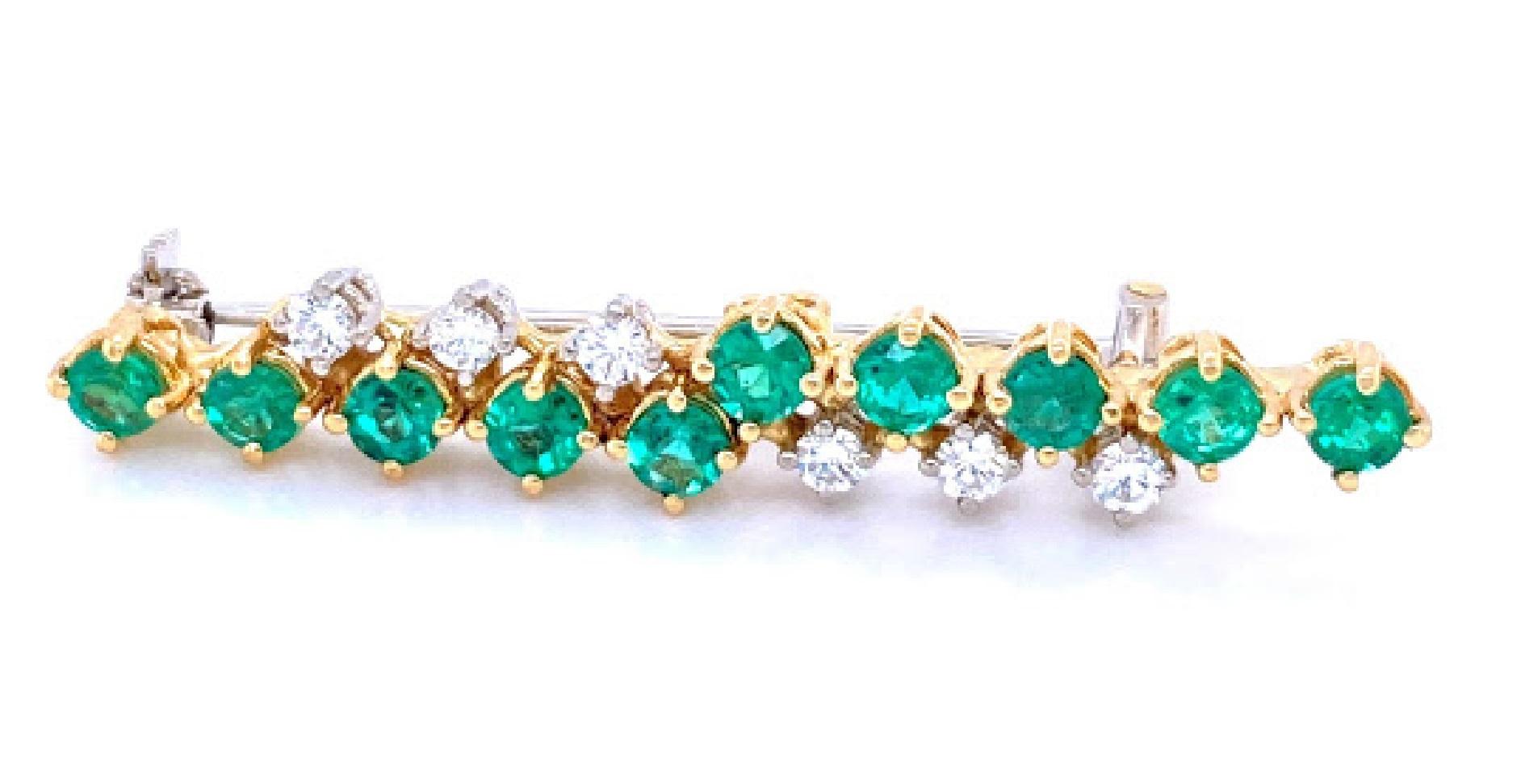 18 karat white and yellow (stamped 18k) gold pin. The pin features 10 round cut emerald stones measuring 3.25 mm, weighing approximately 0.75 carat total weight. With 6 round cut diamonds that are in the H-I color range and the SI clarity range,