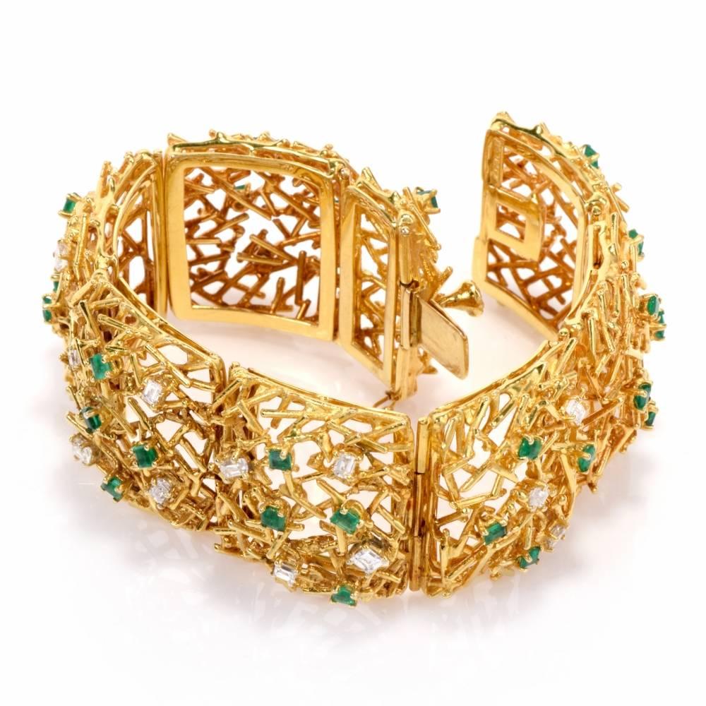 This captivating 1970's  link bracelet with diamonds and emeralds is meticulously handcrafted in 18-karat yellow gold weighing 96.7 grams and measuring 7.5 inches long and 28 mm wide. Comprising 8 immaculately hinged links, the fascinating bracelet