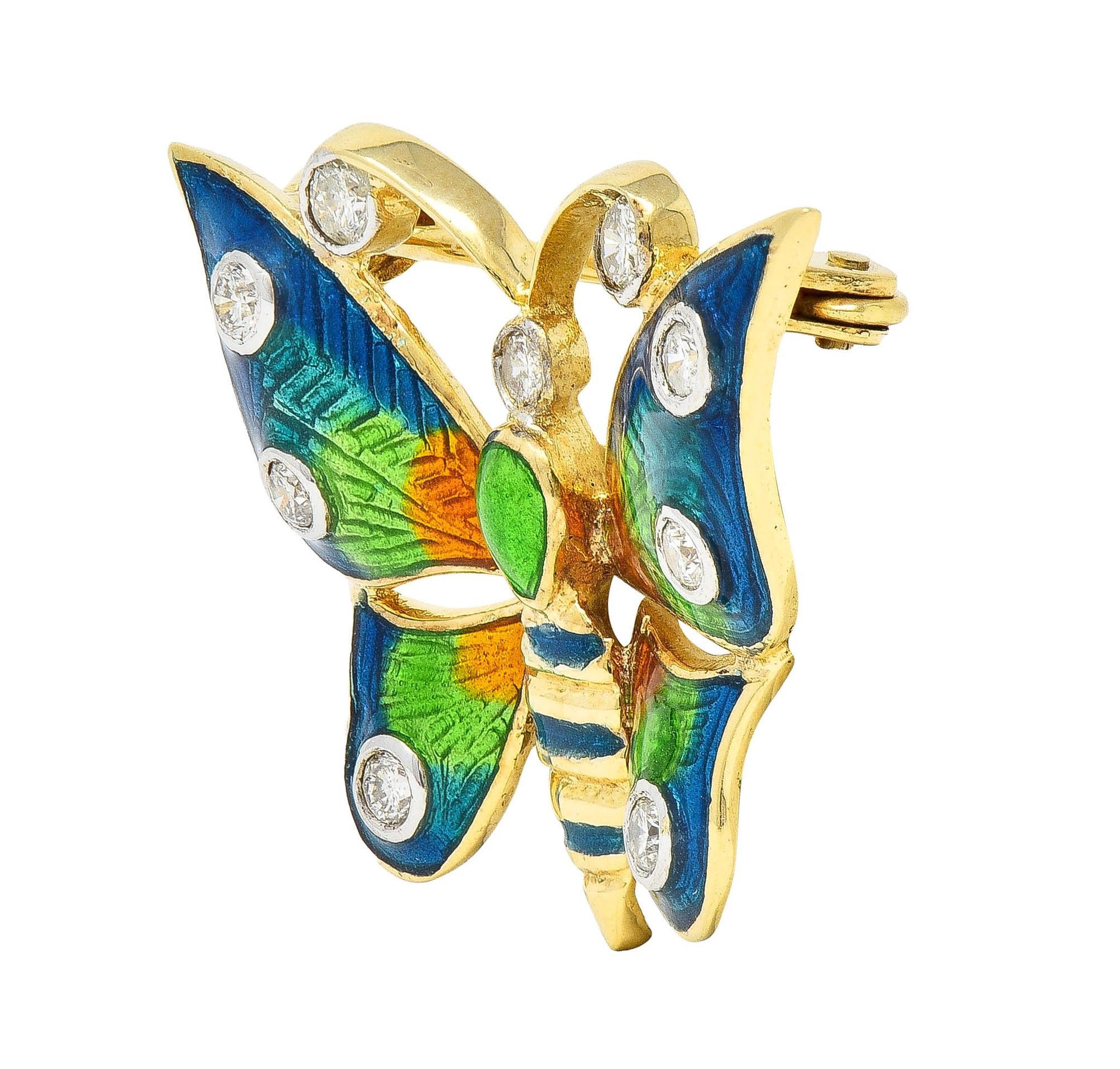Designed as a stylized butterfly with dimensional wings and curling antennae
Wing and body are decorated with guilloche-style transparent enamel 
Ombré blue, teal, green, and orange - glossed over engraved foil
Engraved patterns are geometric and