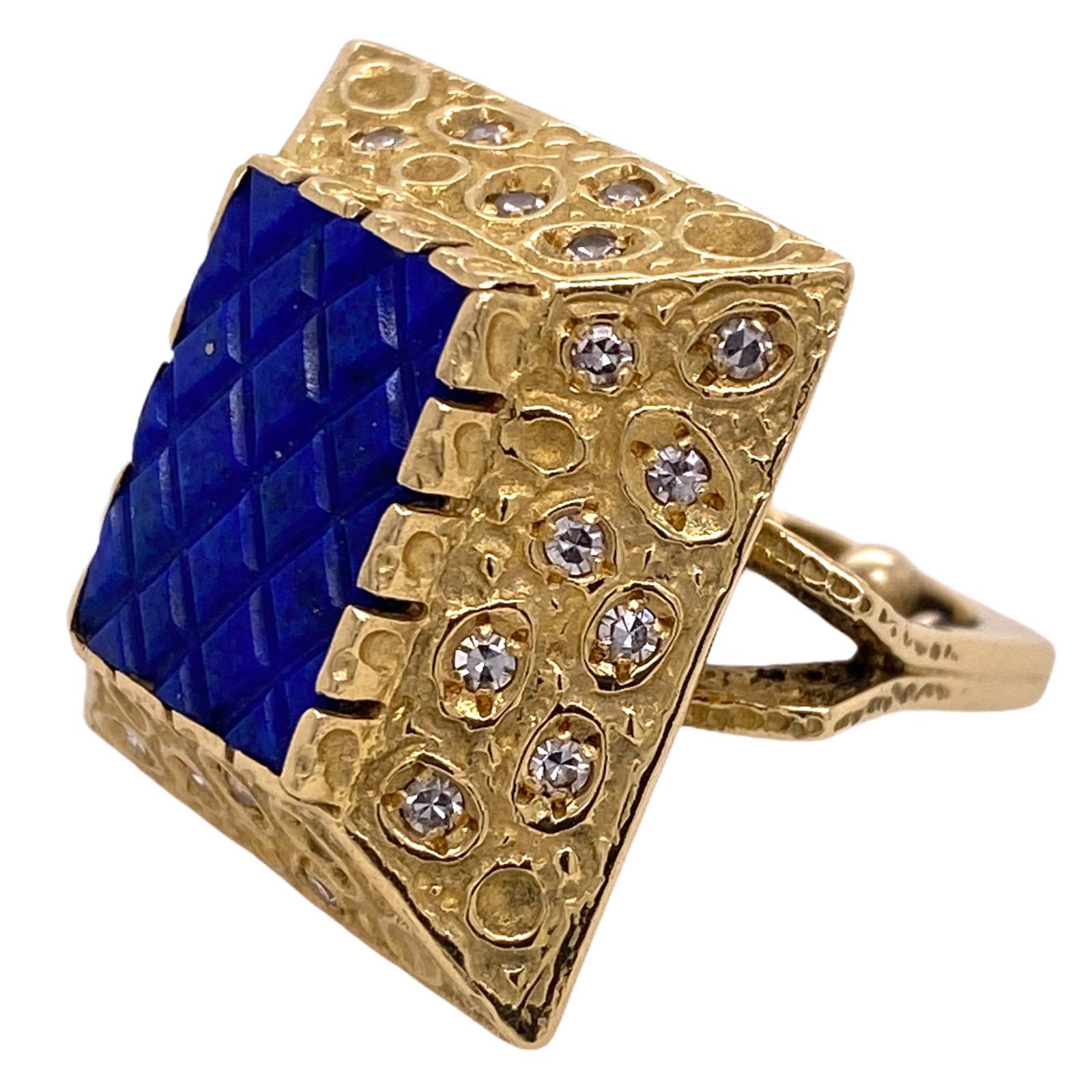 Fabulous lapis lazuli and diamond cocktail ring fashioned in 14 karat yellow gold. The ring features a carved lapis top with 27 surrounding diamonds weighing .50 CTW. The ring is currently size 5 (with sizing beads), size 6 removed. This ring can be